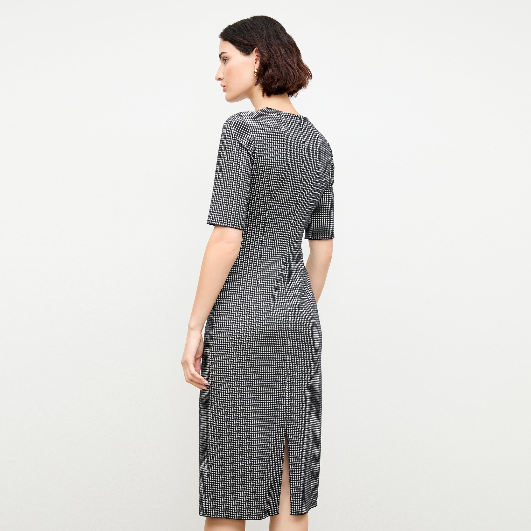 back image of a woman wearing the ciela dress in stretch houndstooth