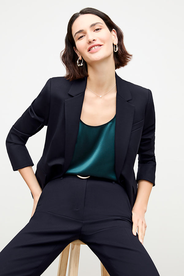 front image of a woman sitting wearing the yiyan petite blazer in galaxy blue