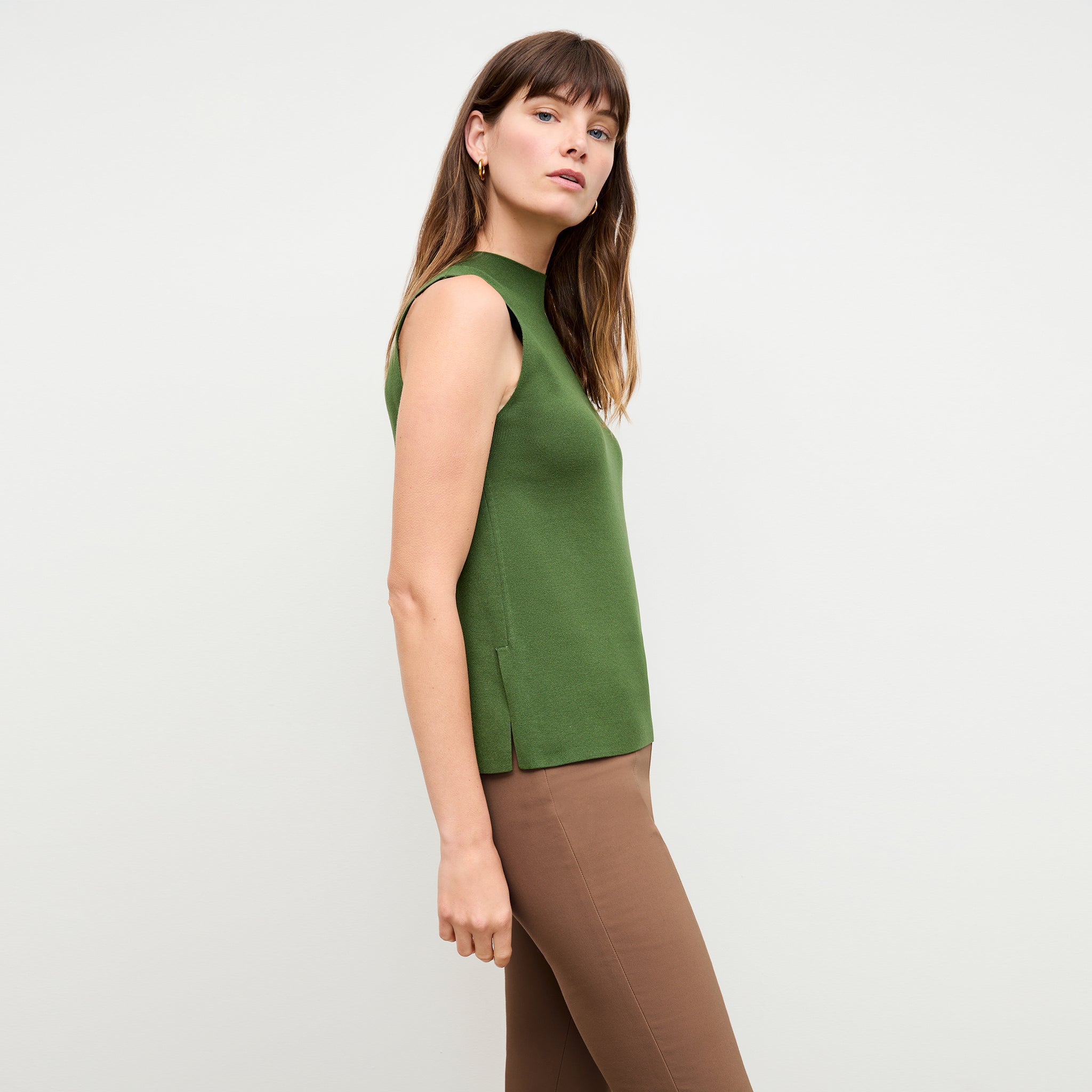 side image of a woman wearing the giulia top in basil