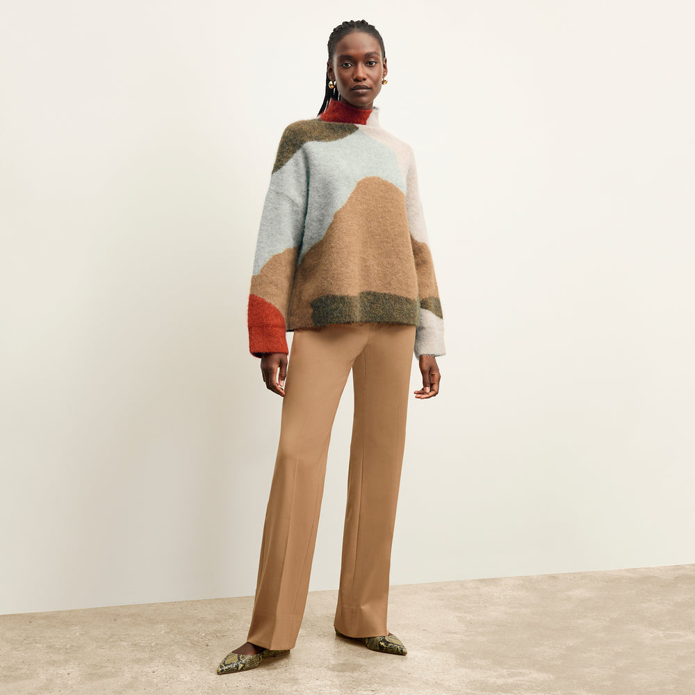 Front image of a woman wearing the Horton pant in camel