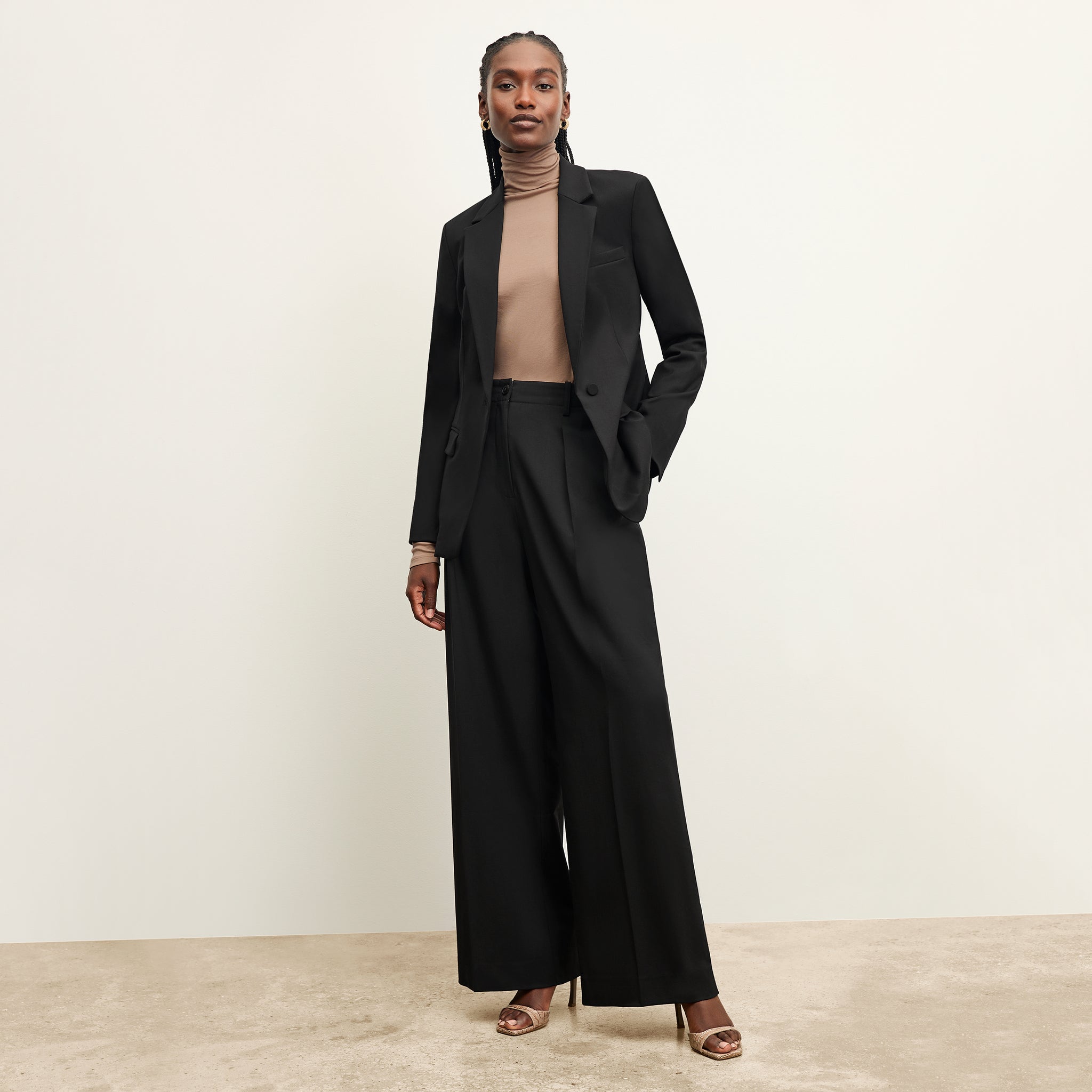  front image of a woman wearing the zuri pant in black