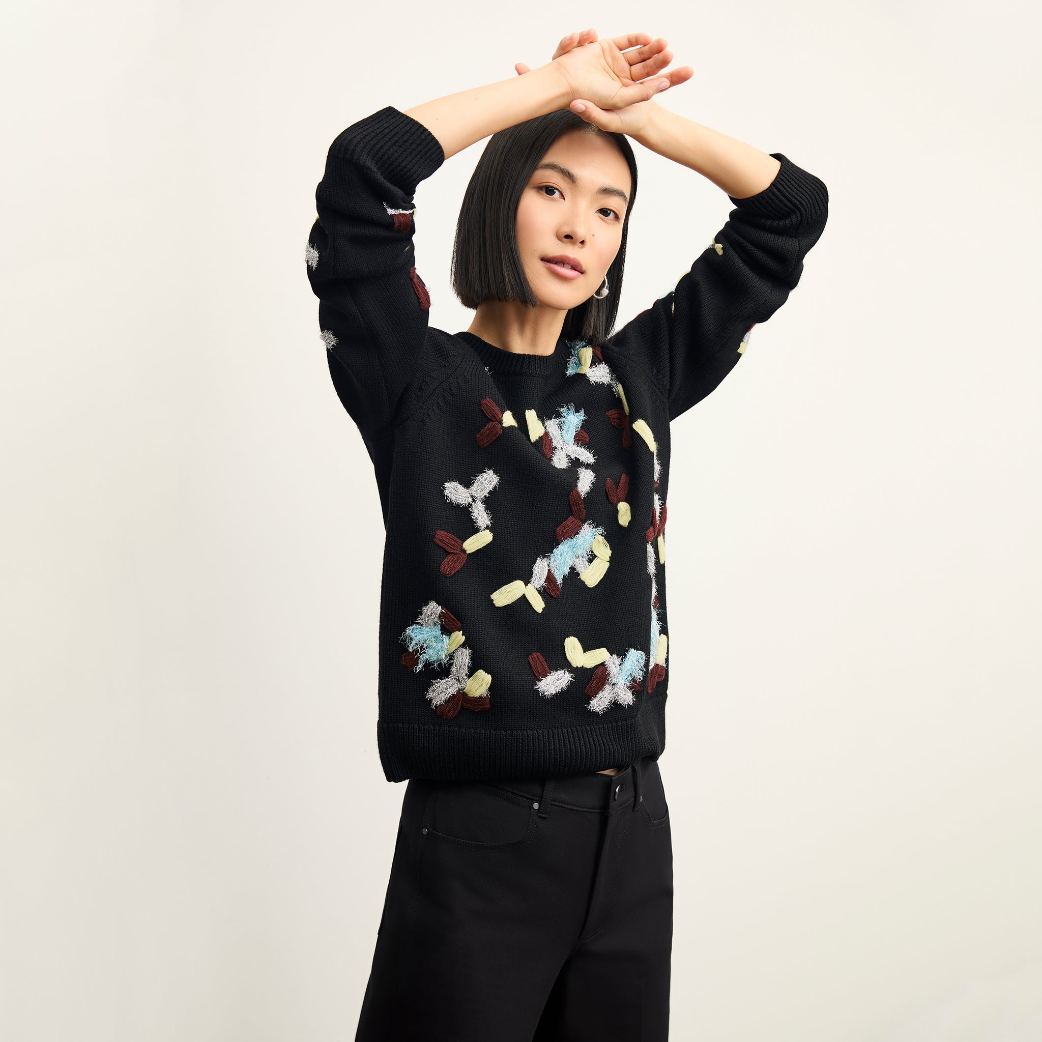 front image of a woman wearing the tish sweater in confetti
