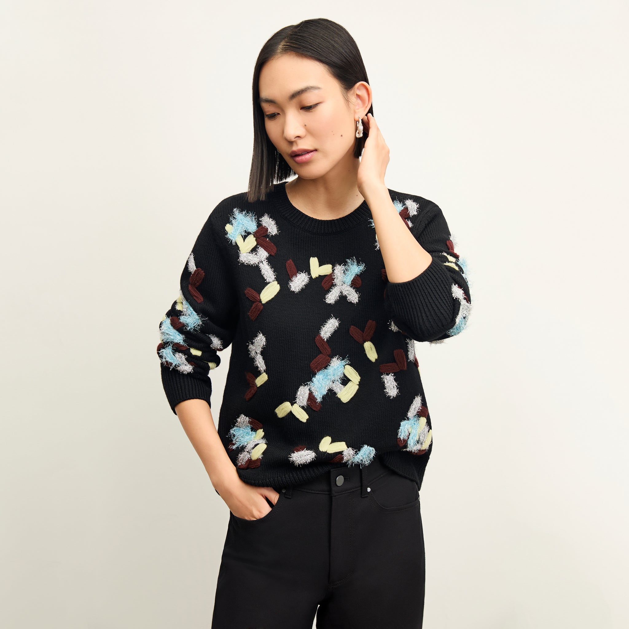 front image of a woman wearing the tish sweater in confetti 