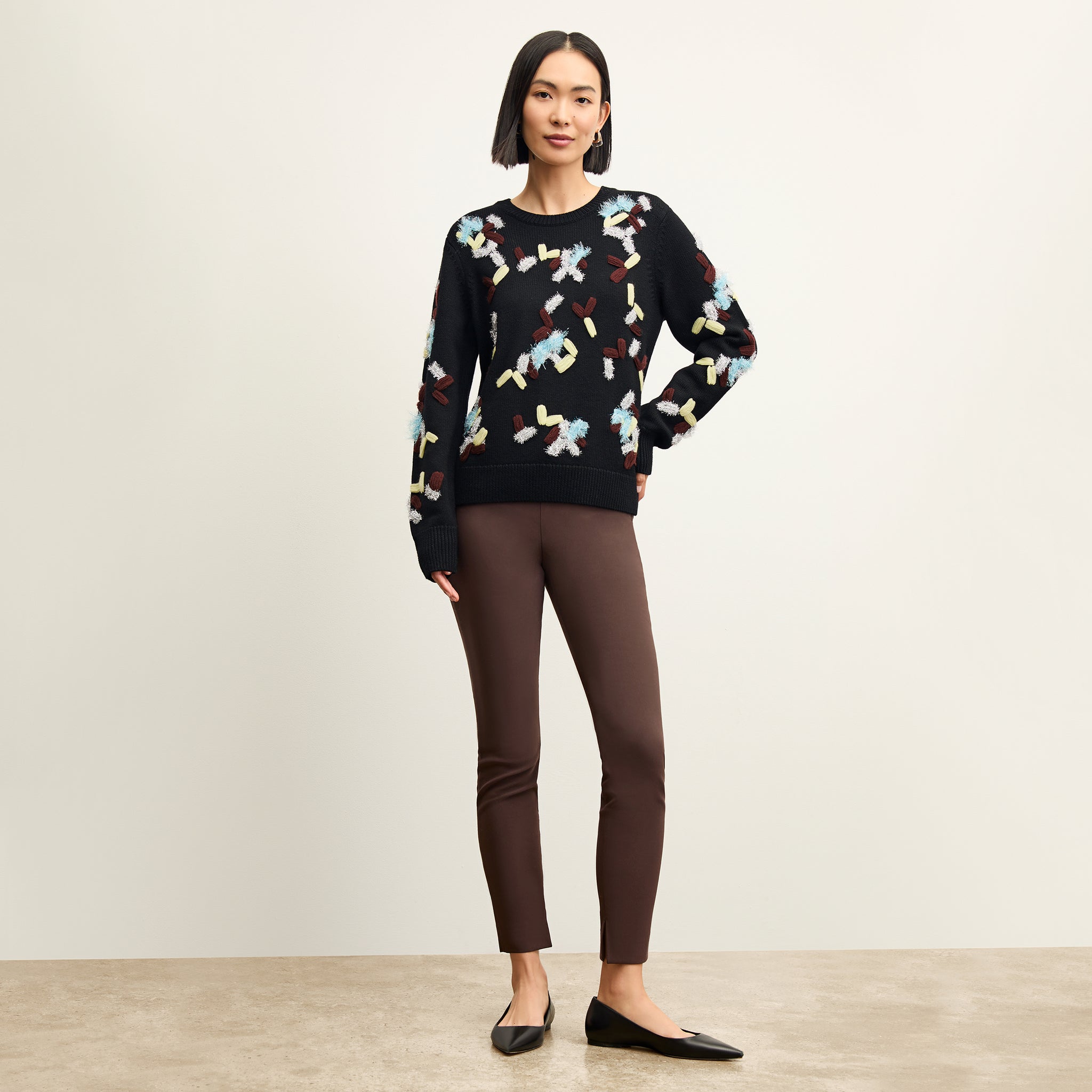 front image of a woman wearing the tish sweater in confetti