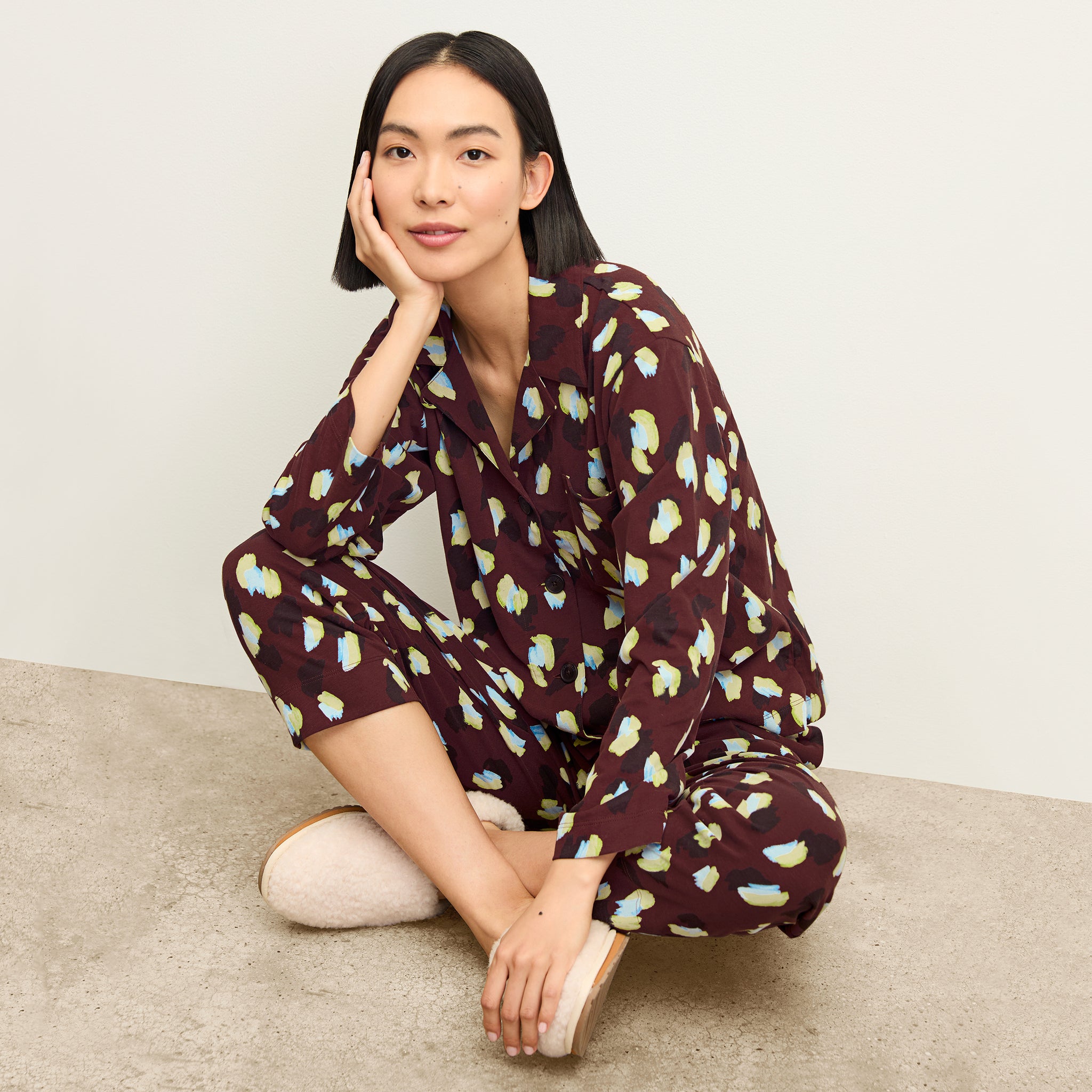 front image of a woman sitting wearing the signature pajama set in bengal print 