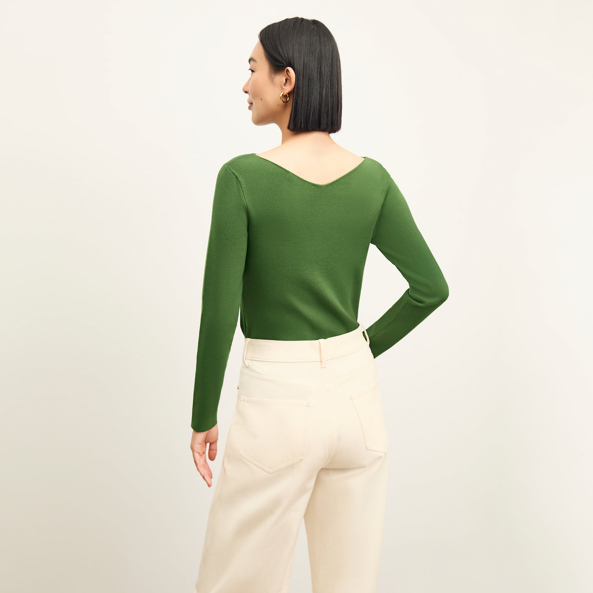 back image of a woman wearing the celeste top in basil
