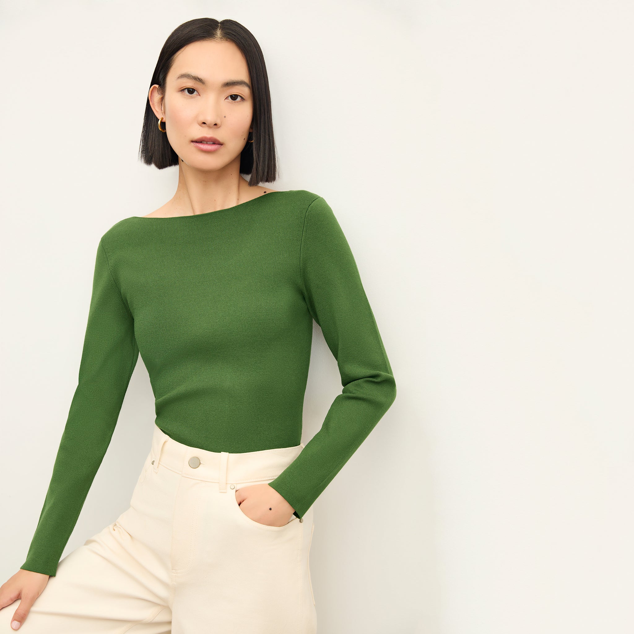 front image of a woman wearing the celeste top in basil 