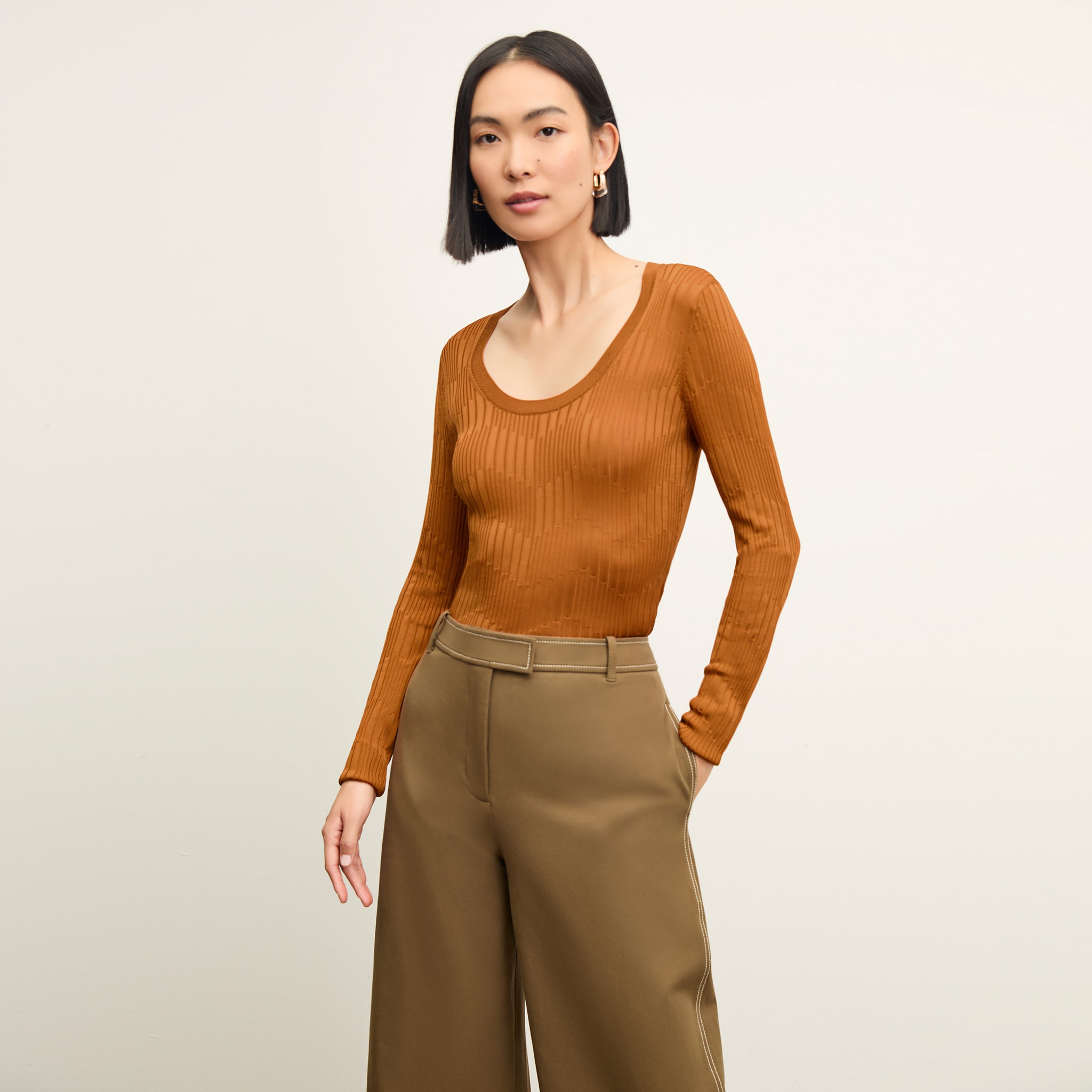 front image of a woman wearing the rae top in caramel 