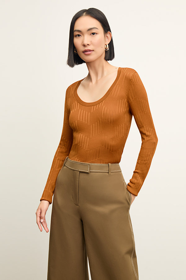 back image of a woman wearing the rae top in caramel