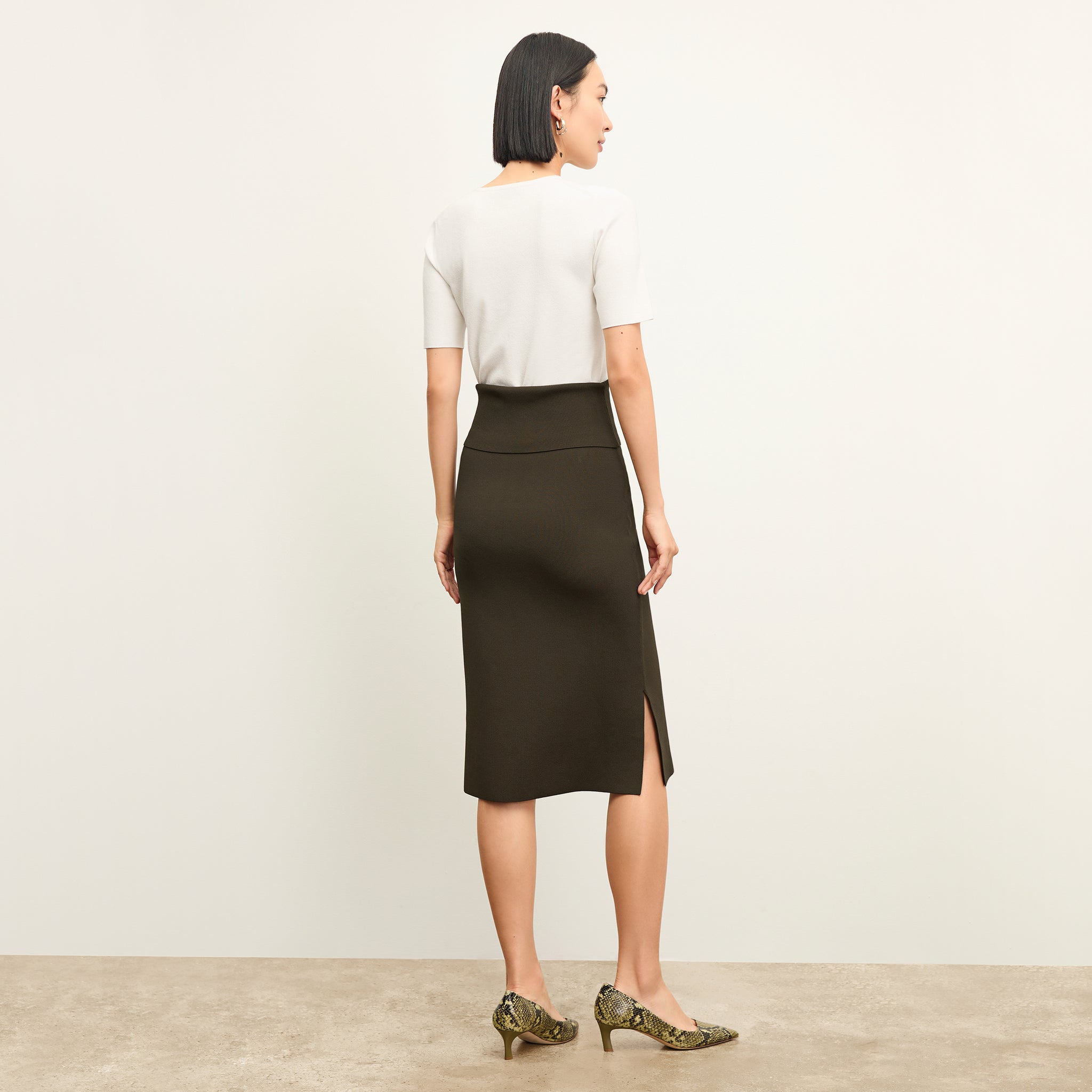 back image of a woman wearing the harlem skirt in dark elm
