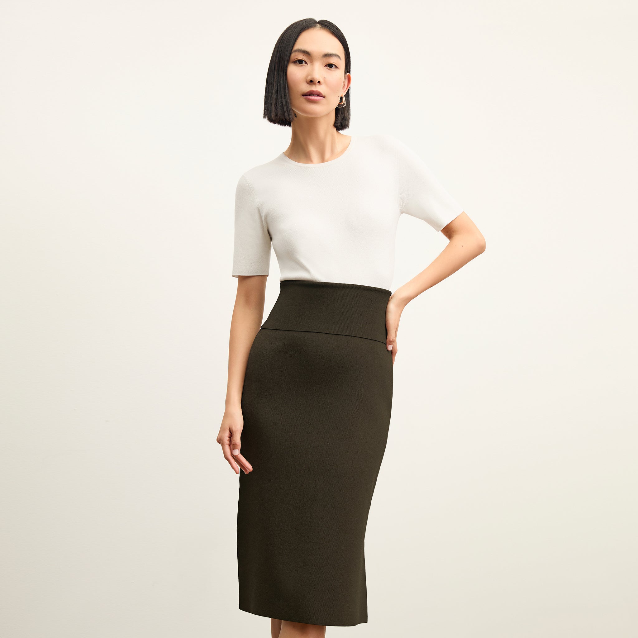 front image of a woman wearing the harlem skirt in dark elm