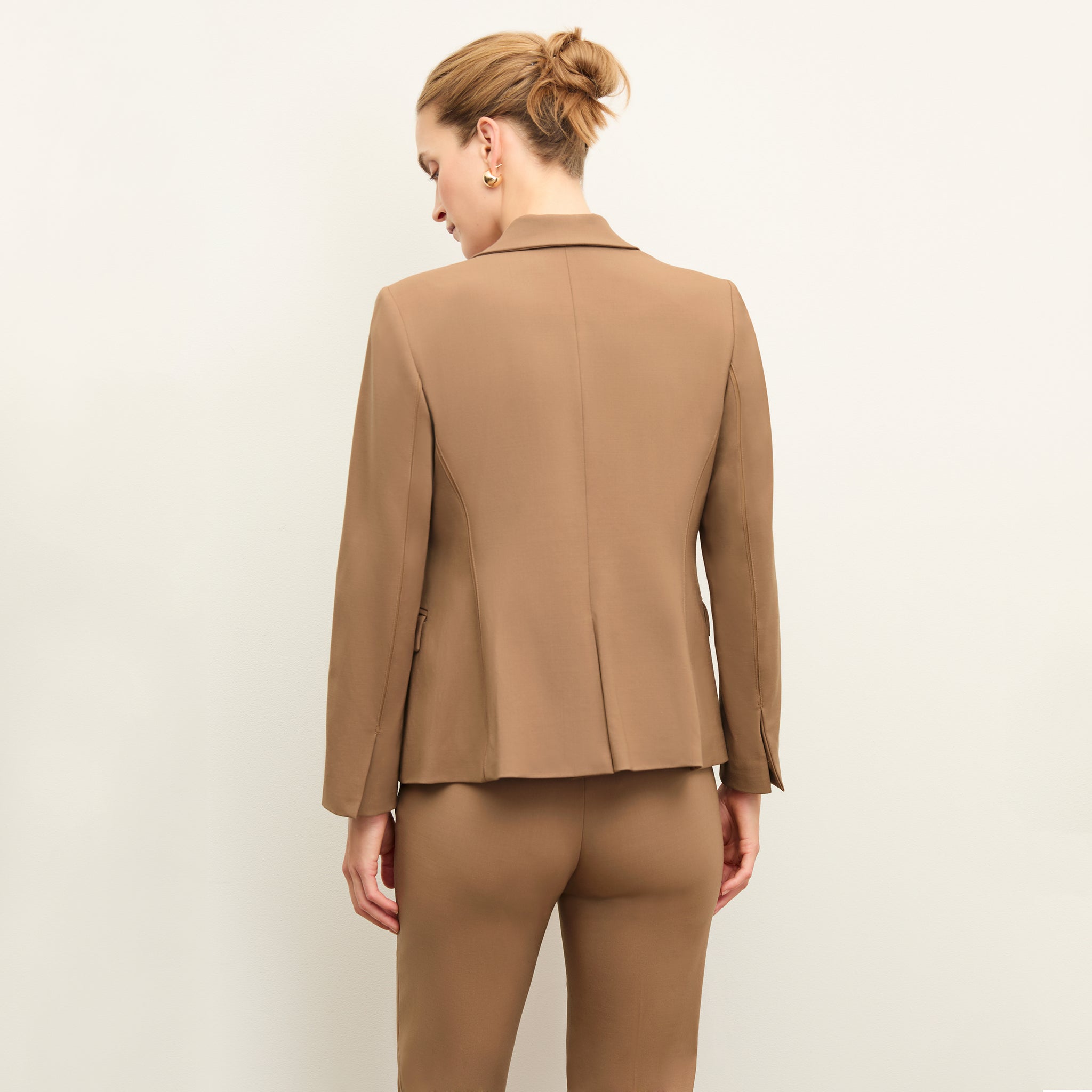 back image of a woman wearing the yasmine blazer in camel