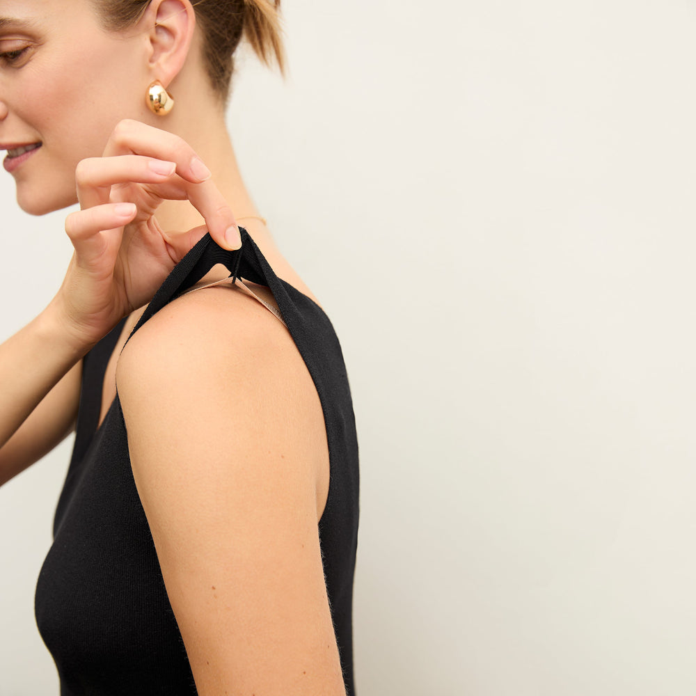 side image of a woman wearing the peggy top in black