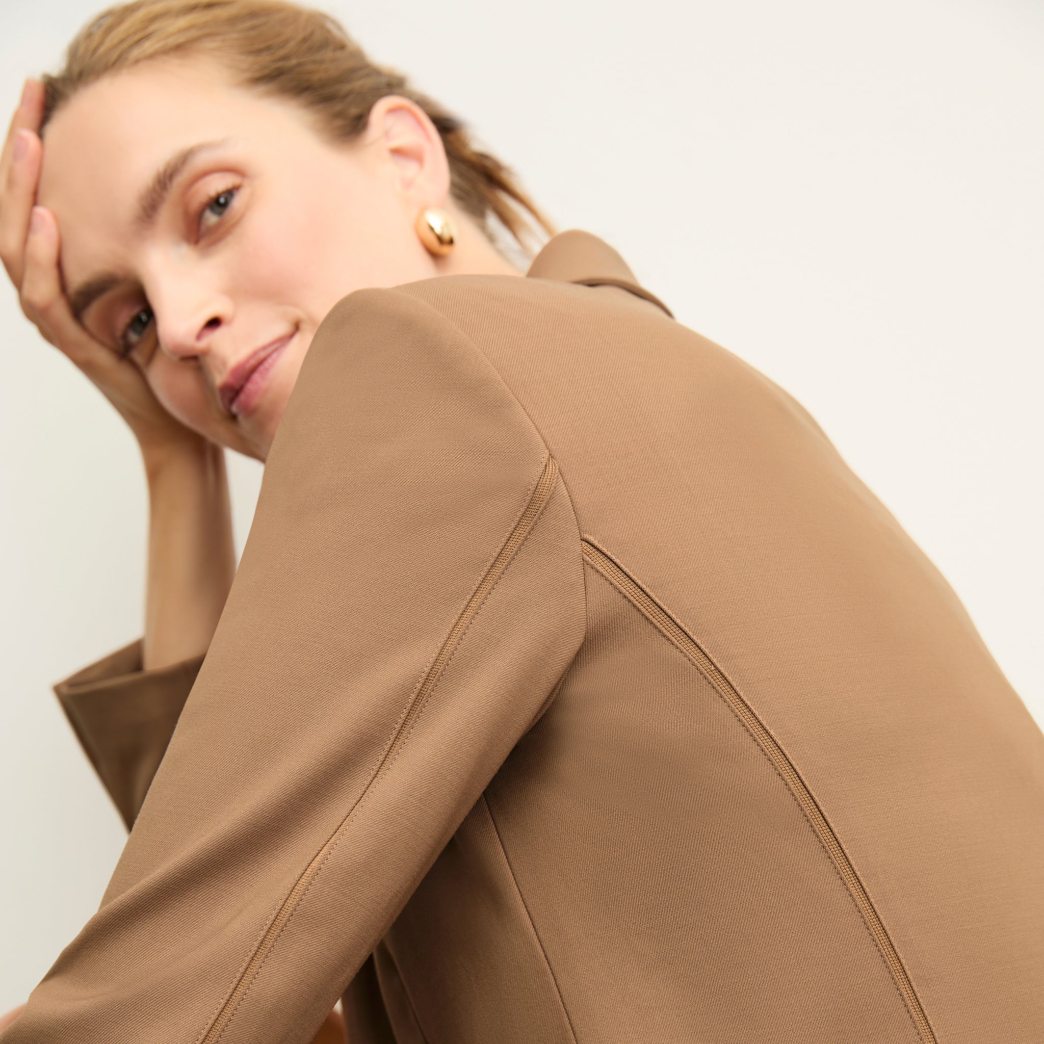 detail image of a woman wearing the yasmine blazer in camel