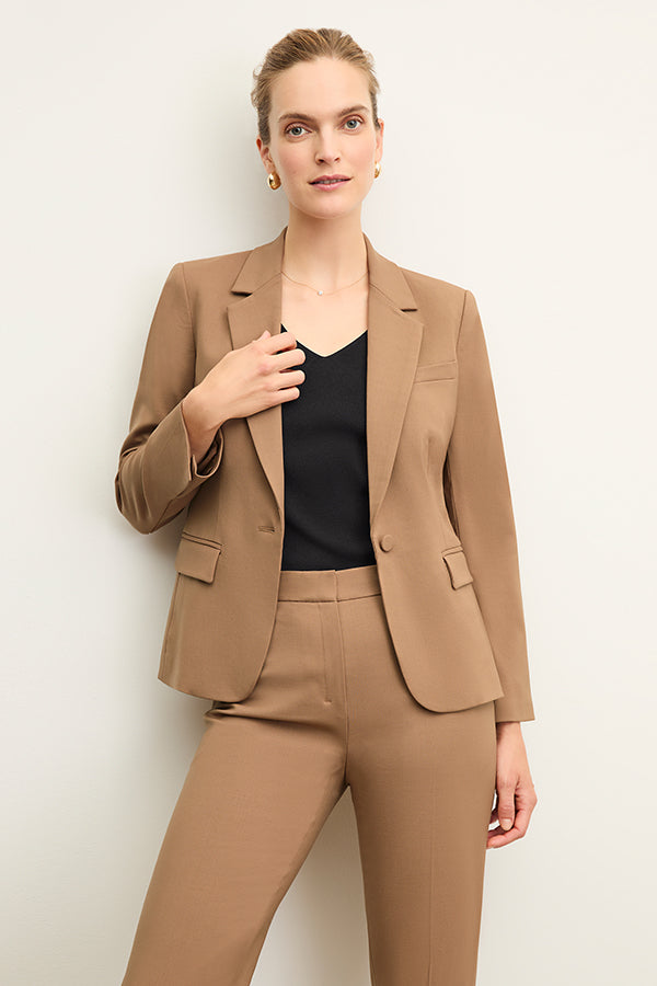 back image of a woman wearing the yasmine blazer in camel