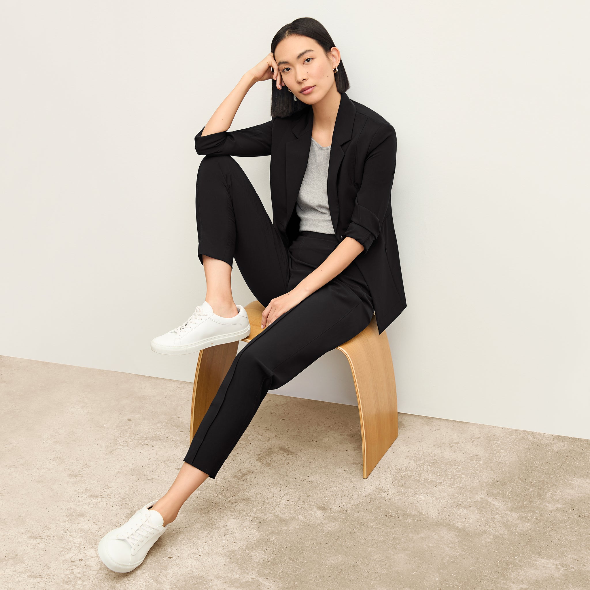 Front image of a woman sitting wearing the Colby Jogger in Black