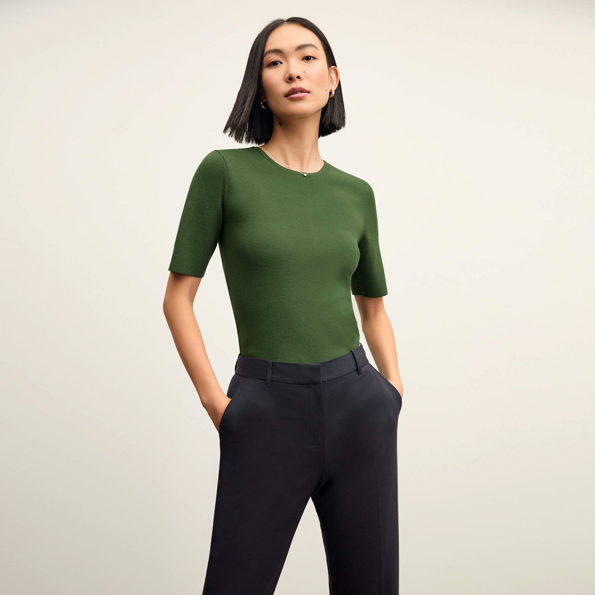 front image of a woman wearing the choe top in basil 