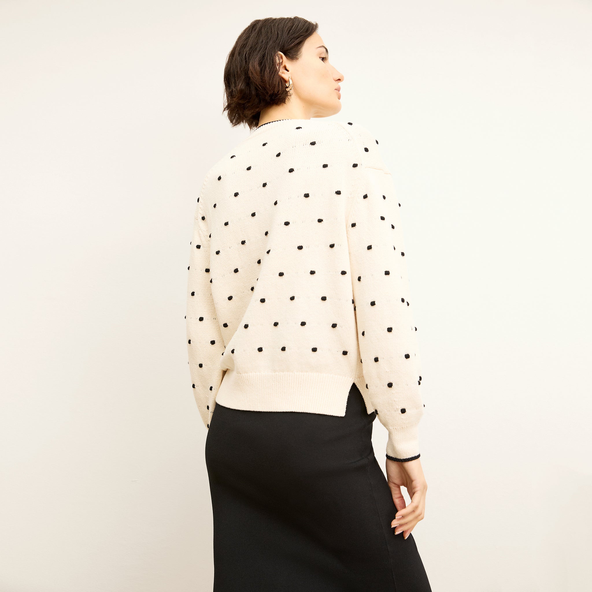 back image of a woman wearing the kim sweater in dot knit