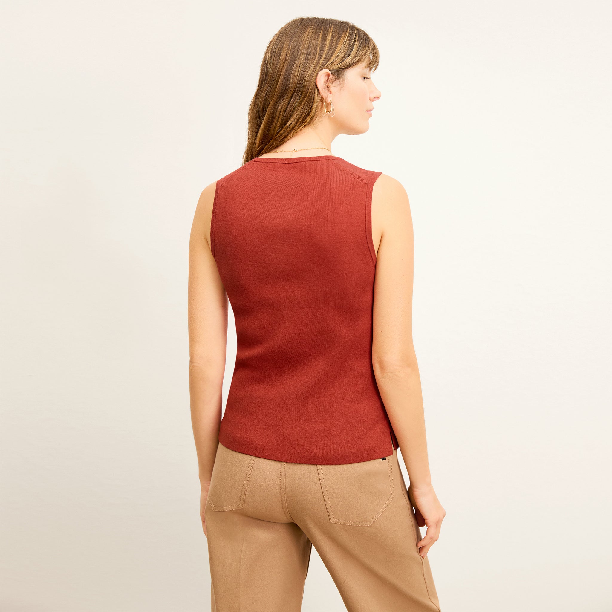back image of a woman wearing the sabine top in amaro