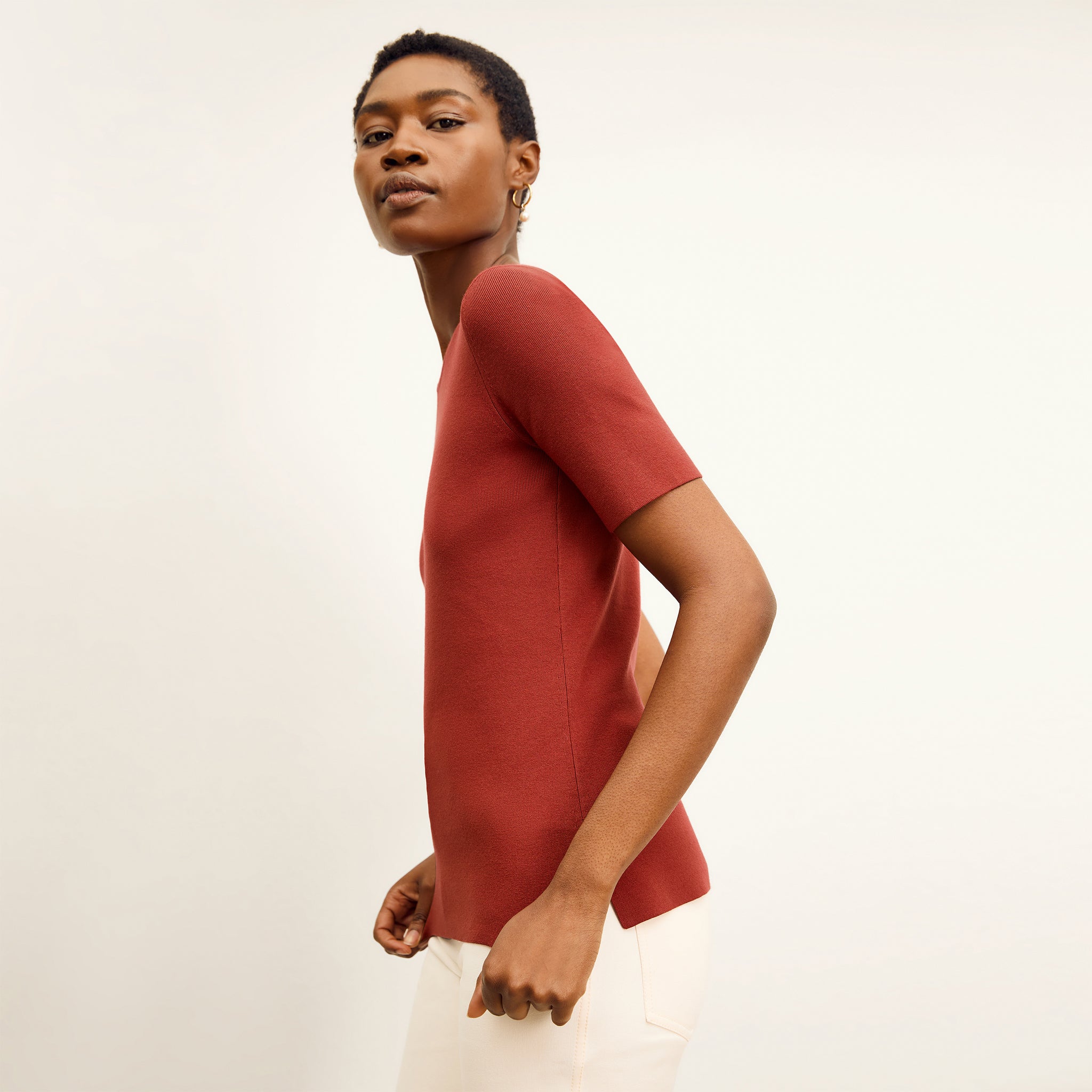 side image of a woman wearing the choe top in amaro