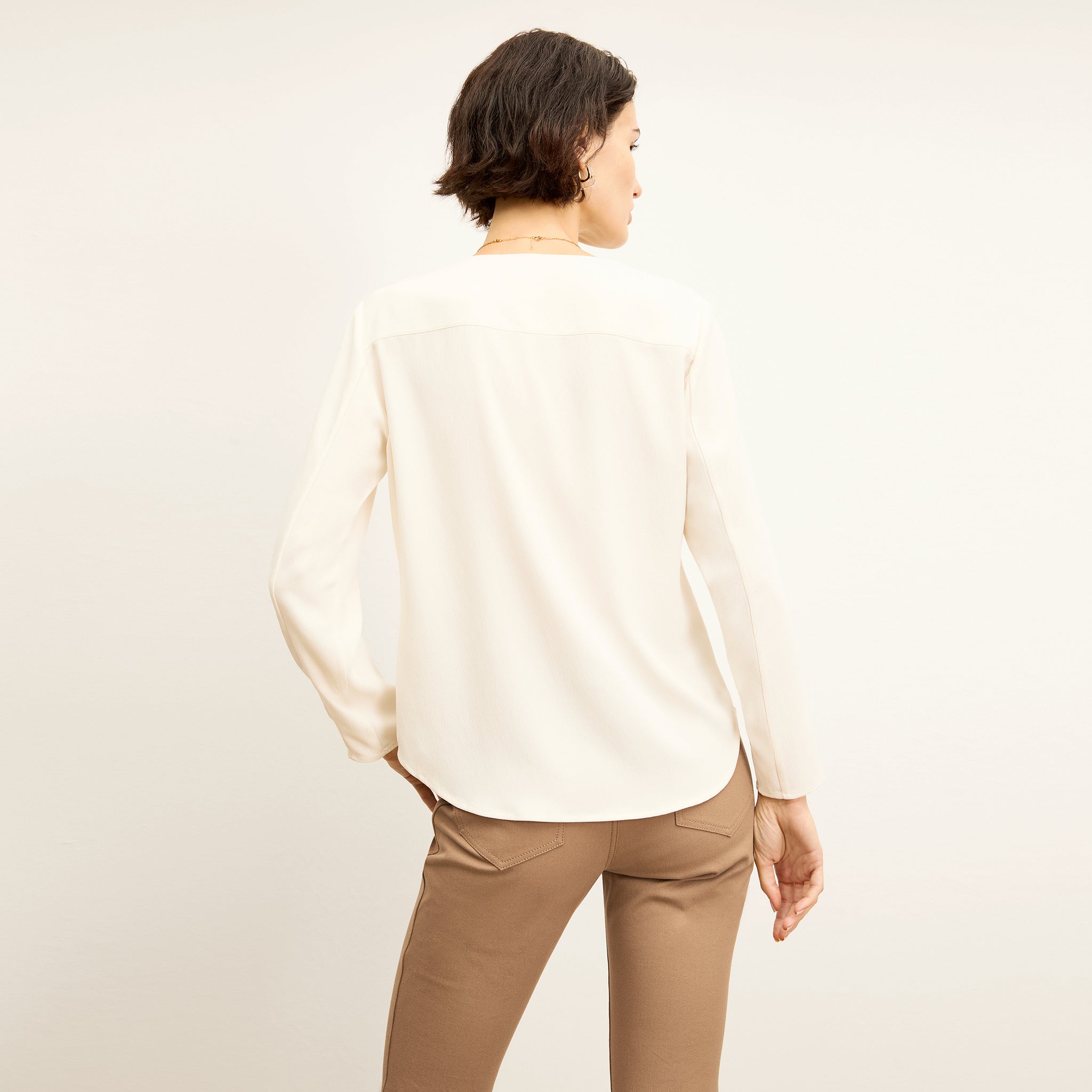 back image of a woman wearing the bobbie top in alabaster