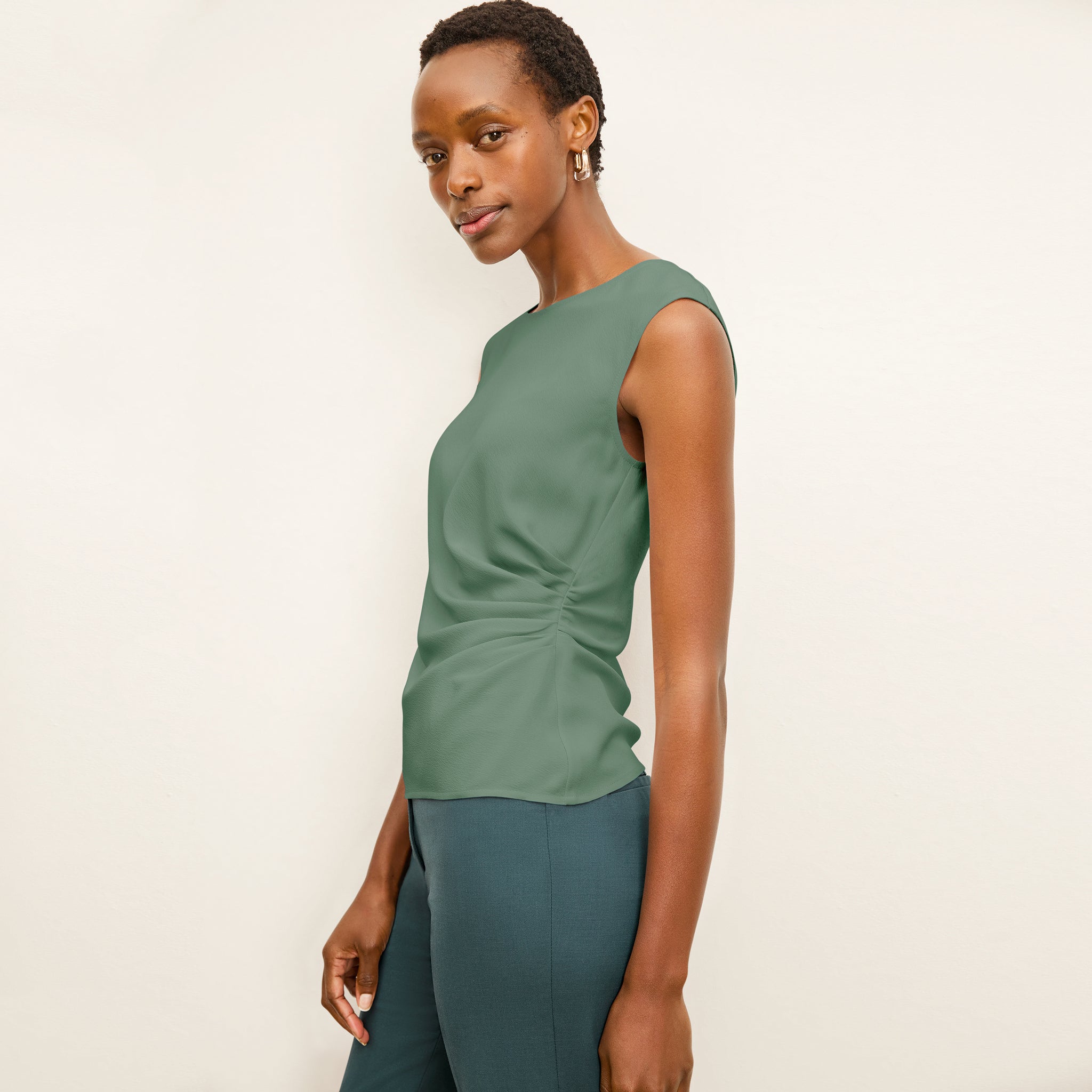 side image of a woman wearing the brooke top in riverstone