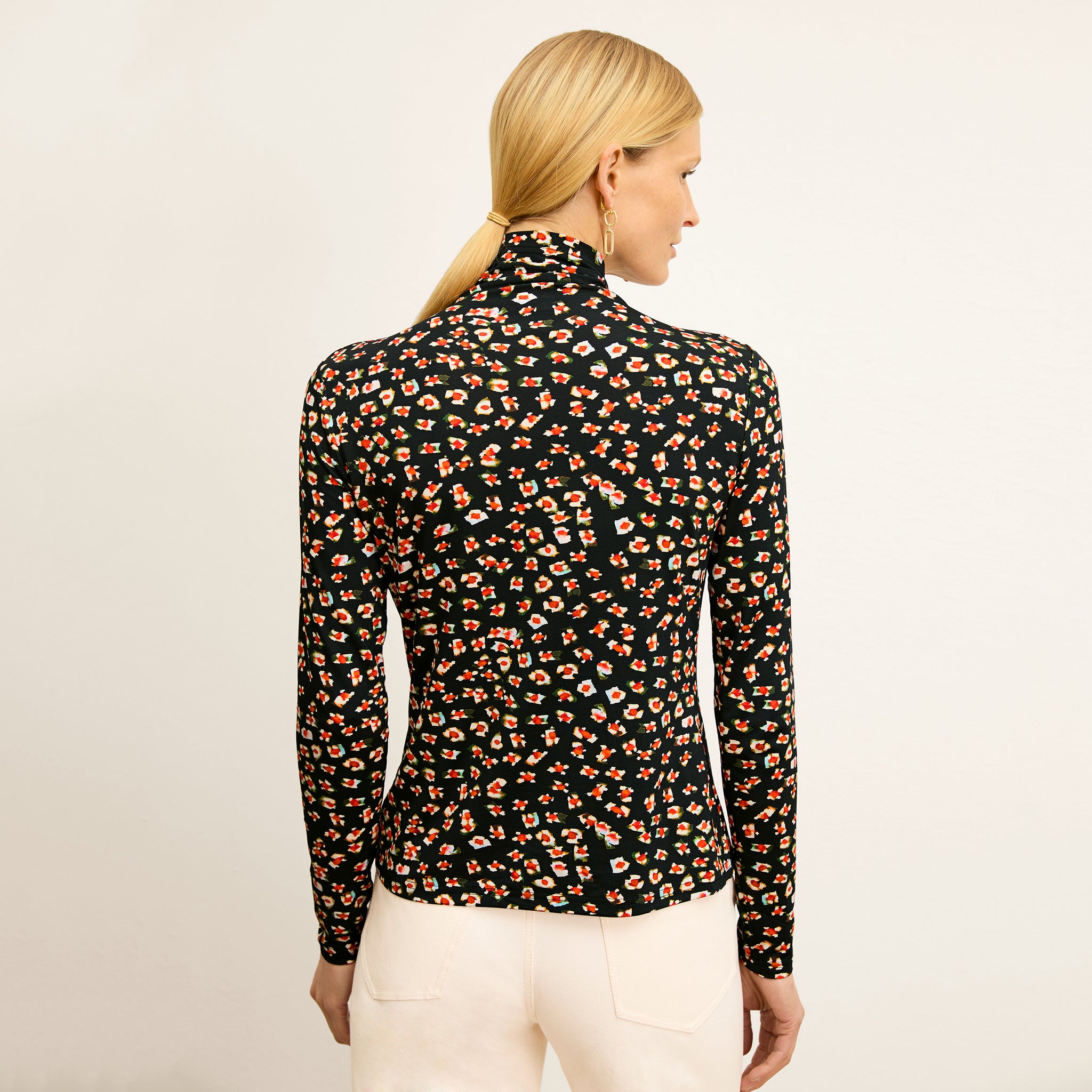 back image of a woman wearing the axam top in kaleidoscope print