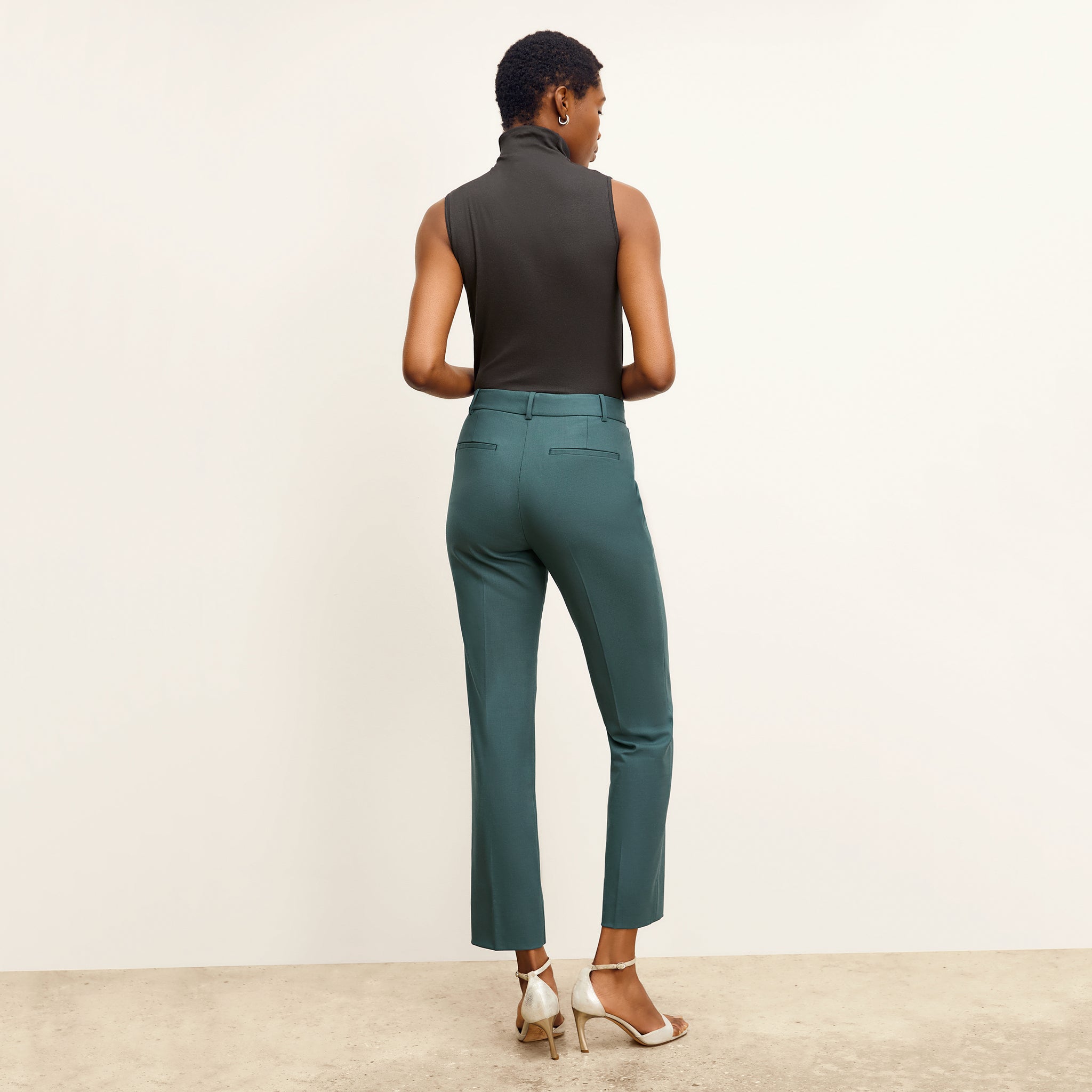 back image of a woman wearing the smith pants in blue jade