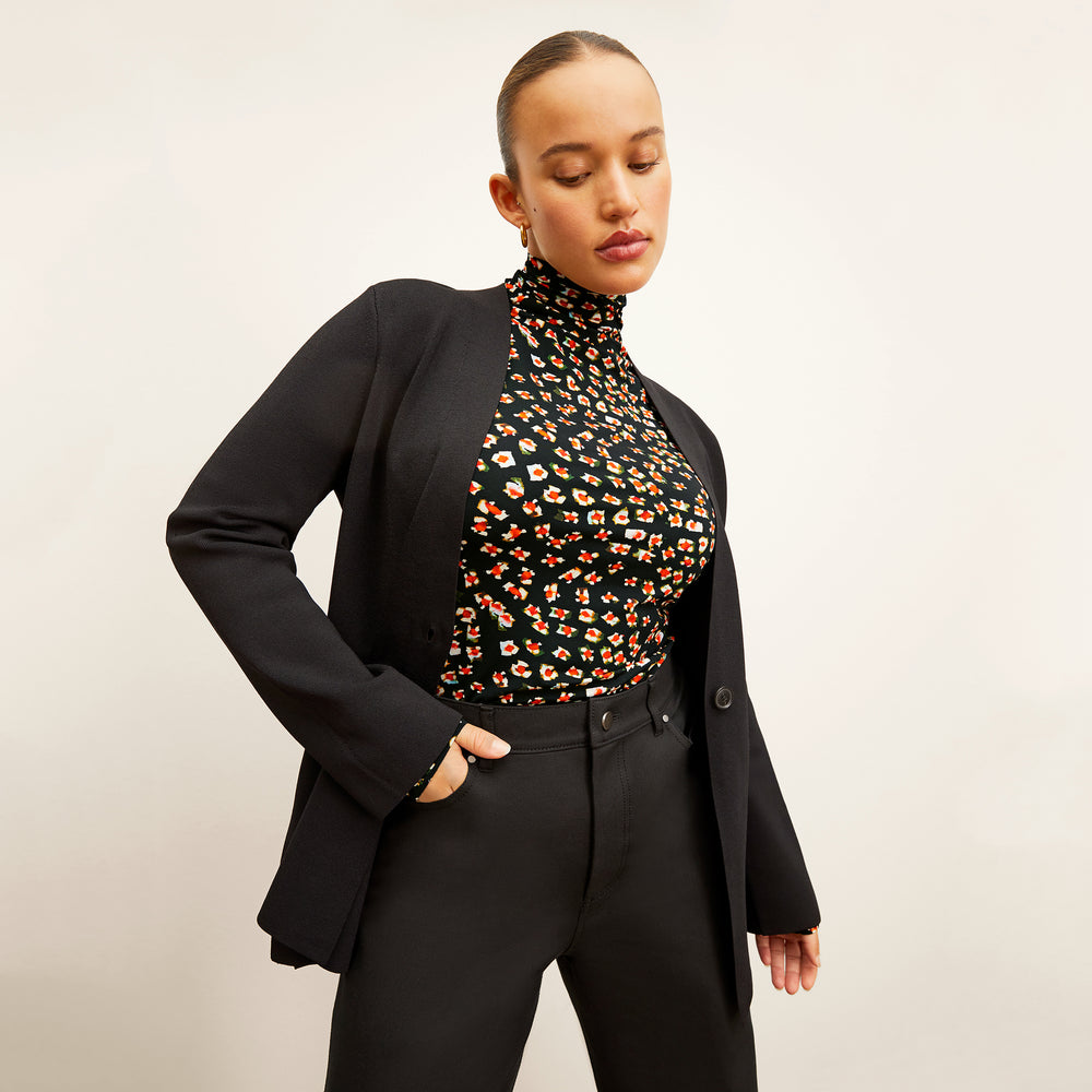 front image of a woman wearing the jennimai jardigan in black