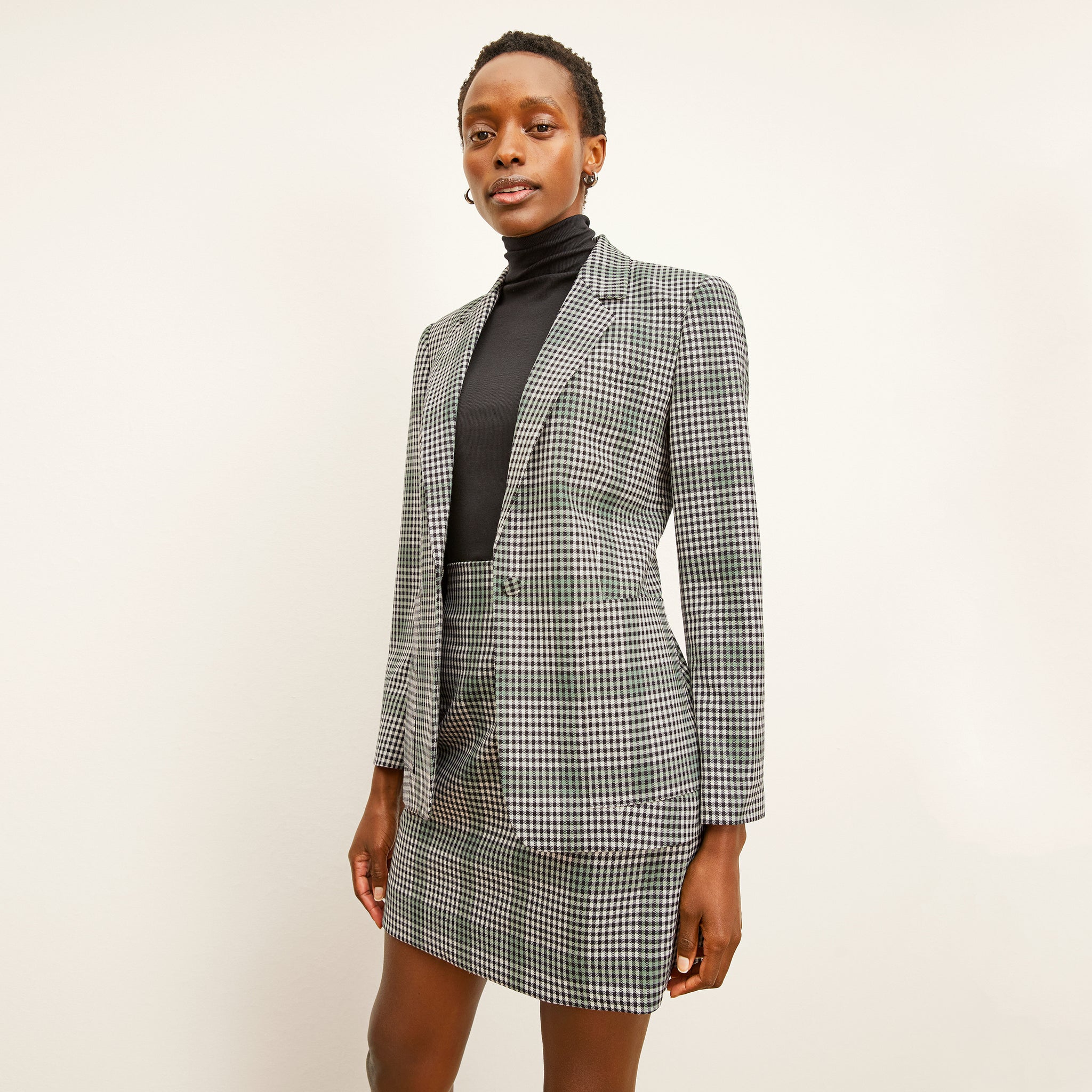 front image of a woman wearing the dolly jacket in check plaid