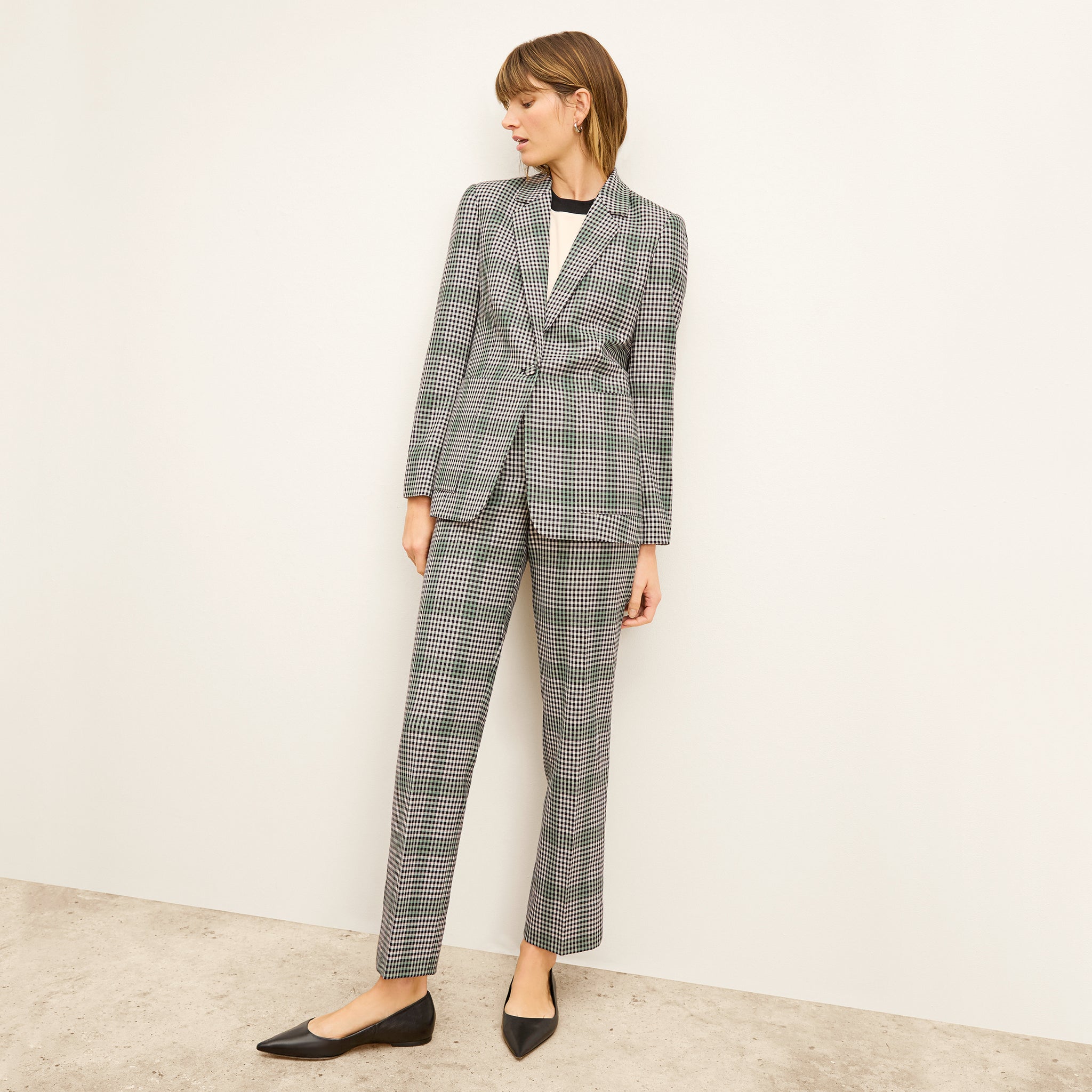front image of a woman wearing the dolly jacket in check plaid