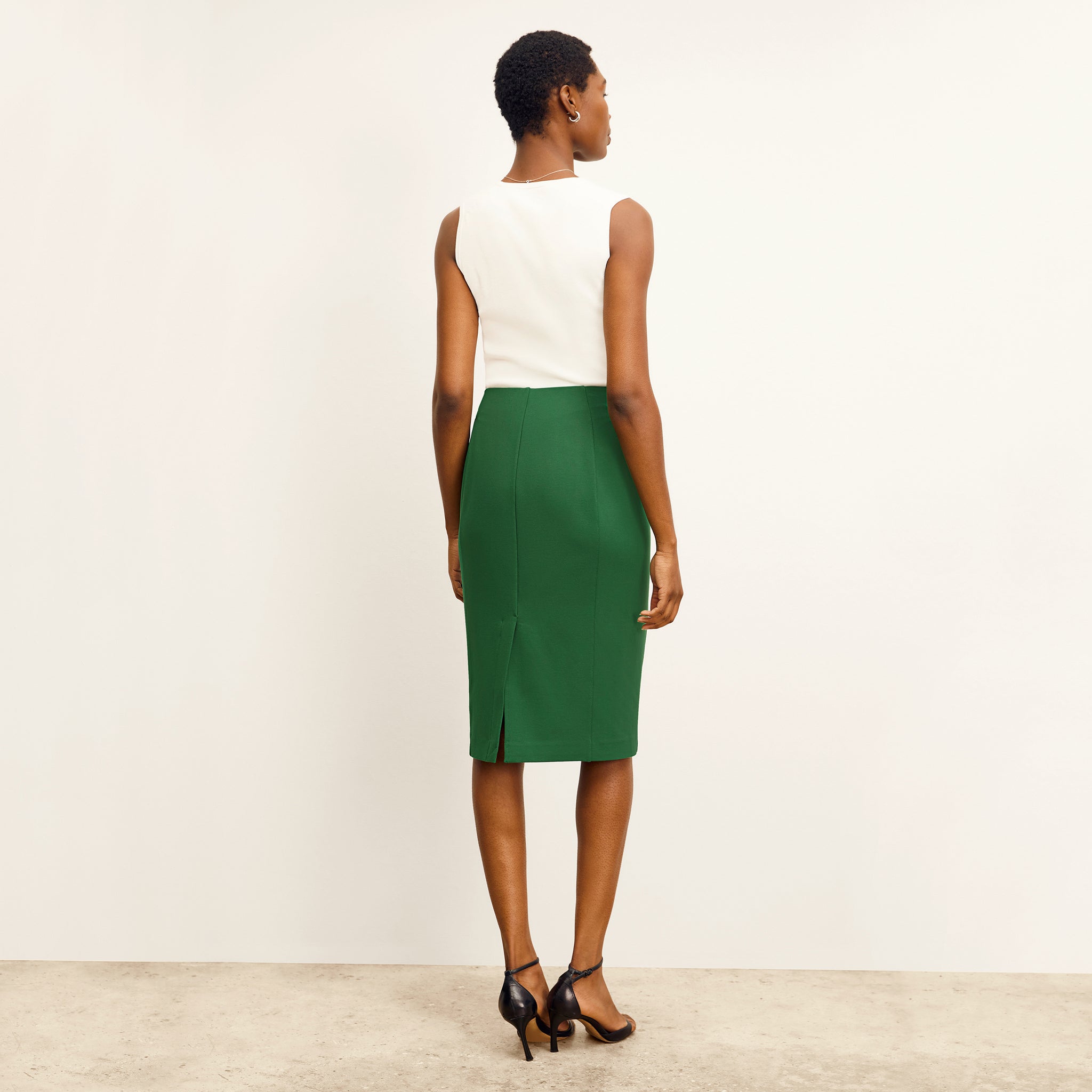 back image of a woman wearing the chantal skirt in shamrock