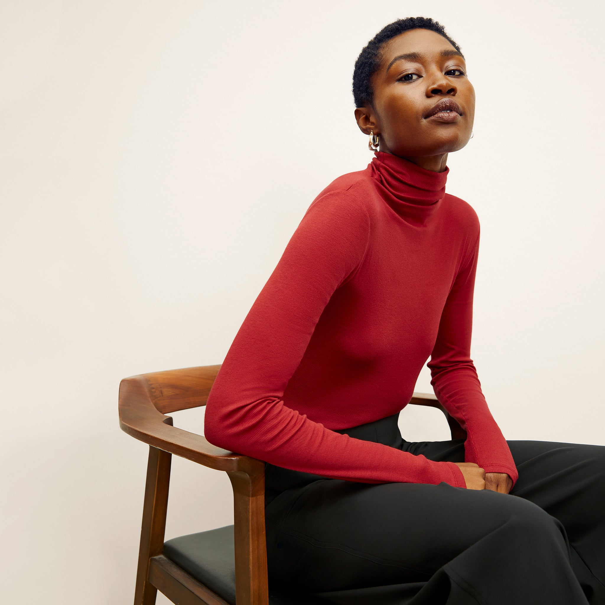 front image of a woman wearing the axam turtleneck in cardinal 