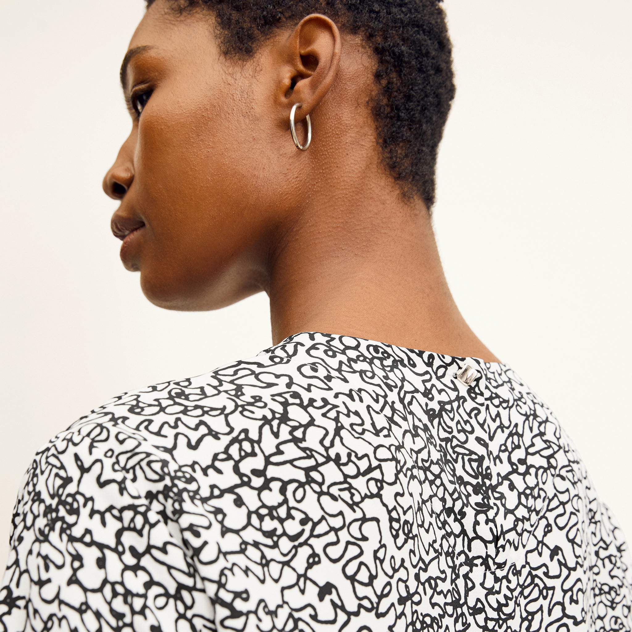 back detail image of a woman wearing the annika top in scribble print
