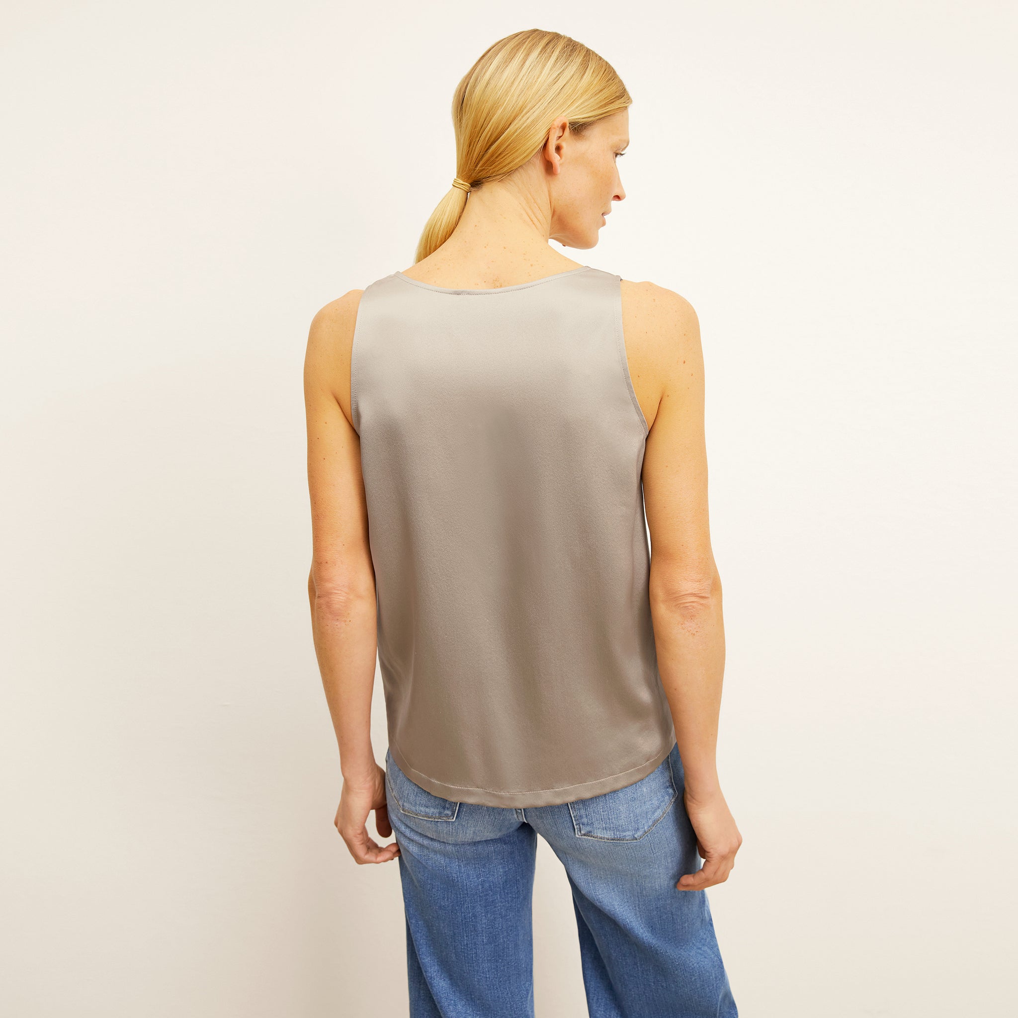back image of a woman wearing the vicky tank in dune