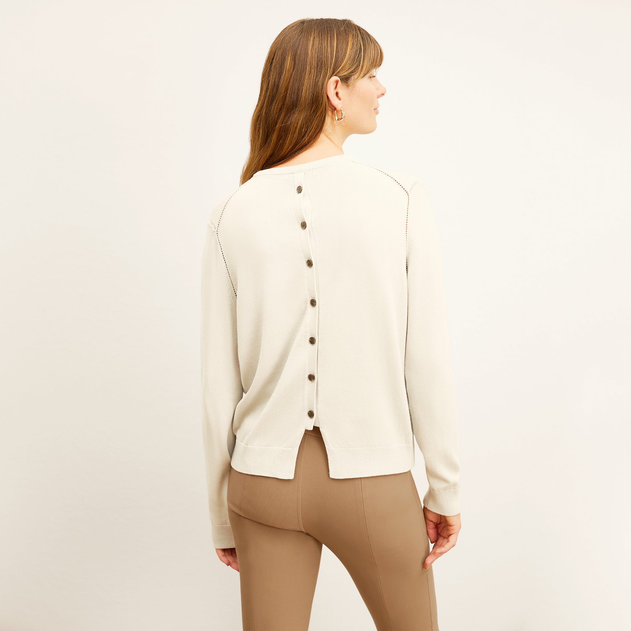 back image of a woman wearing the larissa sweater in ivory