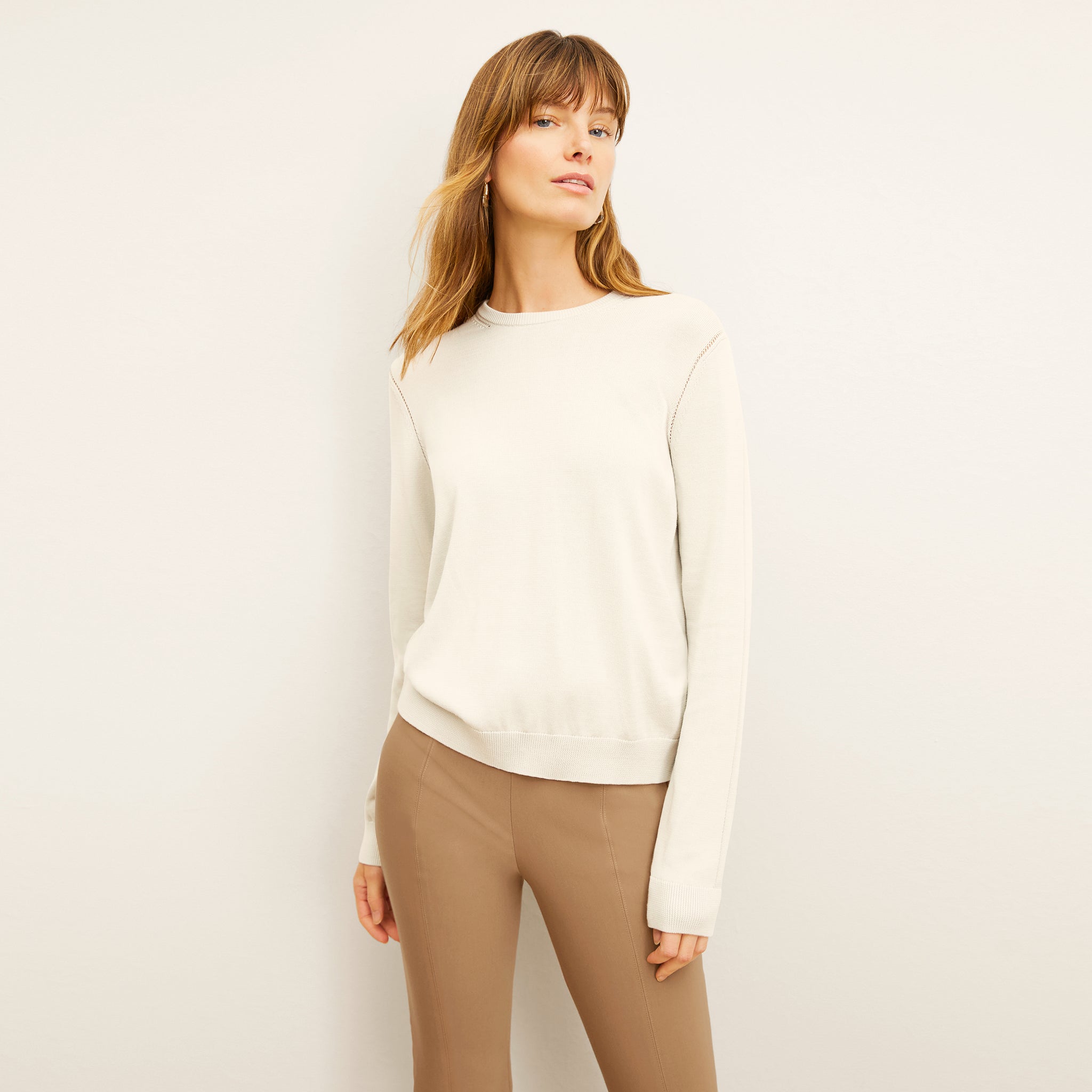 front image of a woman wearing the larissa sweater in ivory 