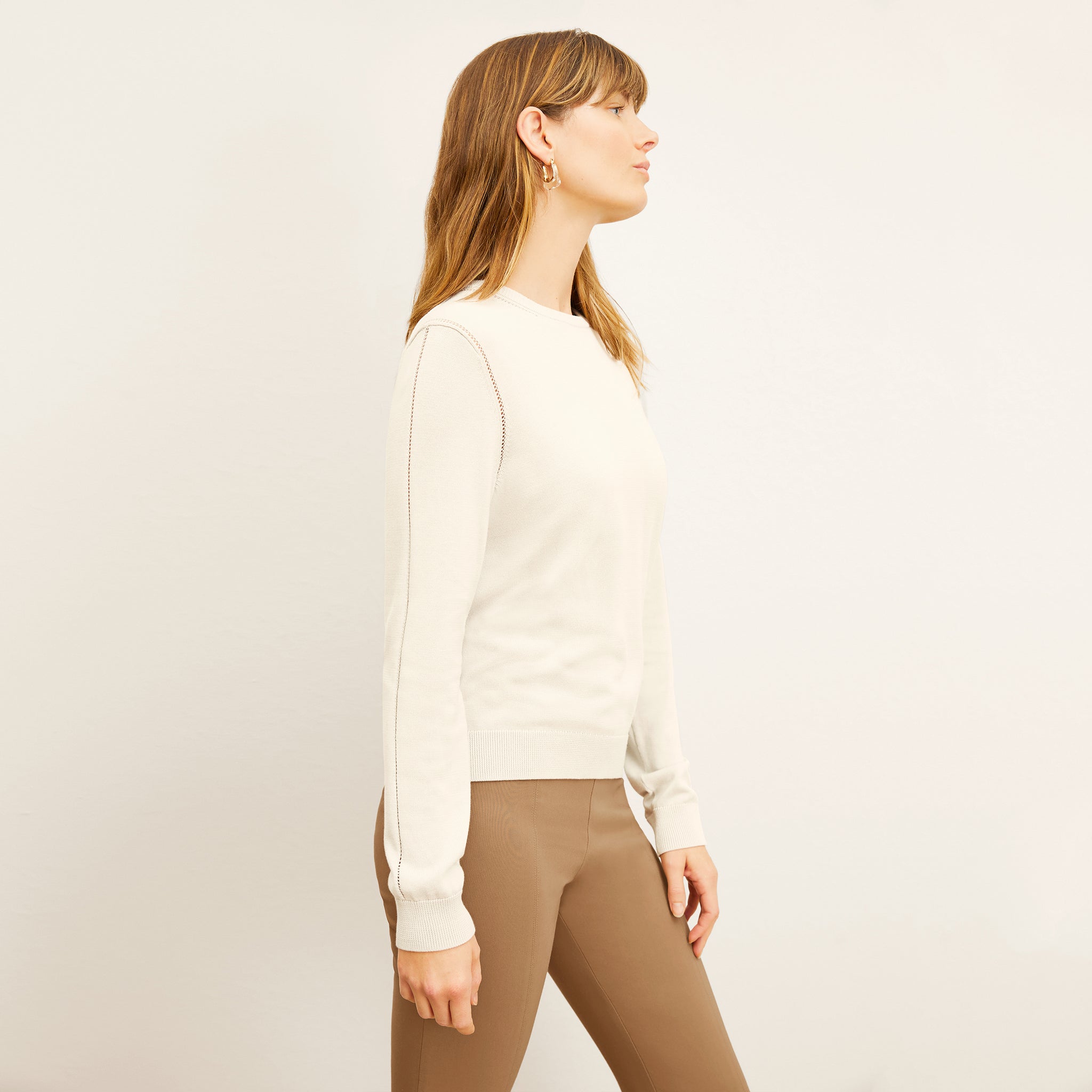 front image of a woman wearing the larissa sweater in ivory