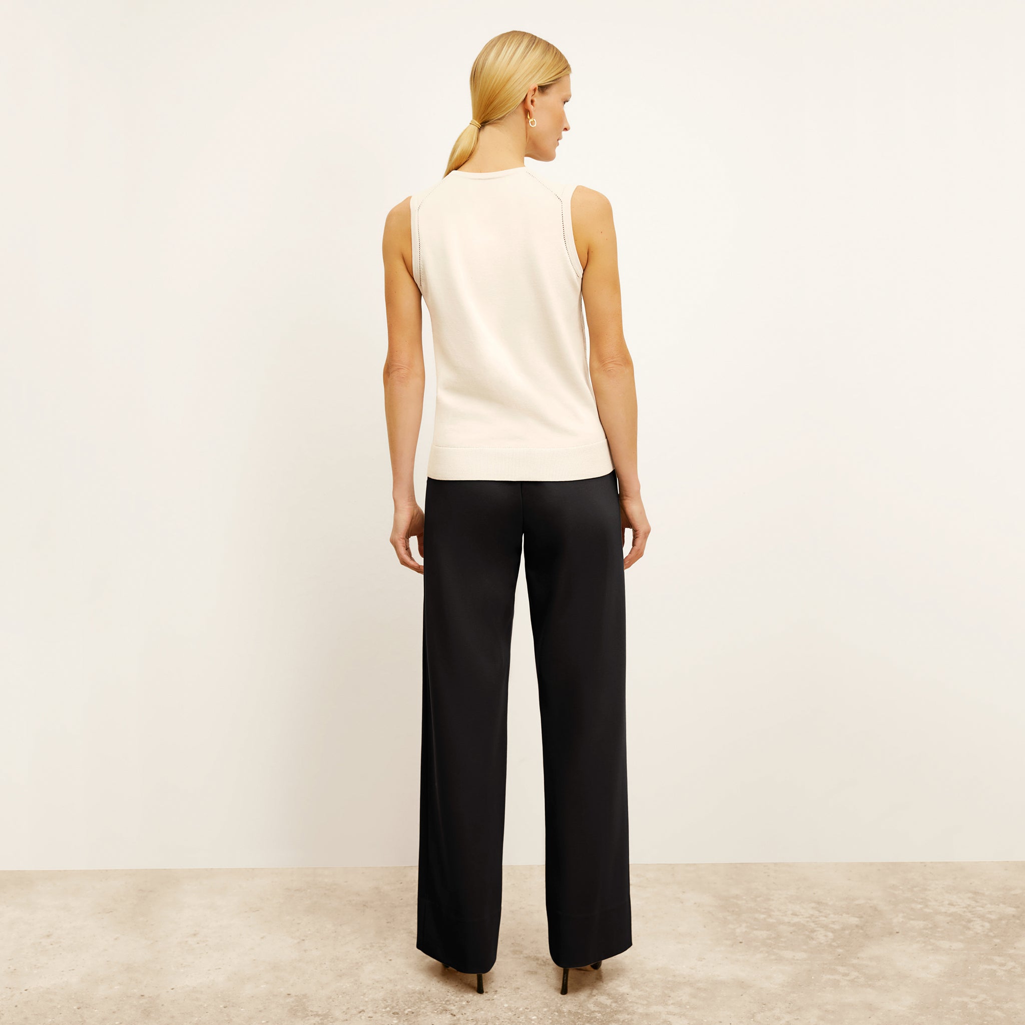 back image of a woman wearing the crimmins top in ivory