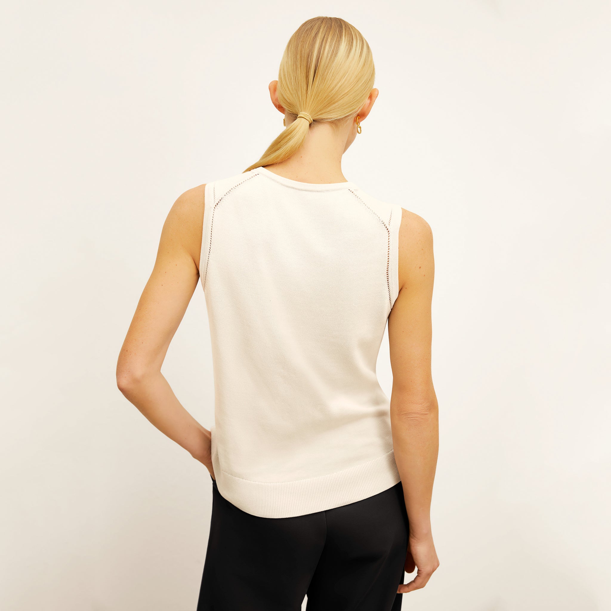back image of a woman wearing the crimmins top in ivory