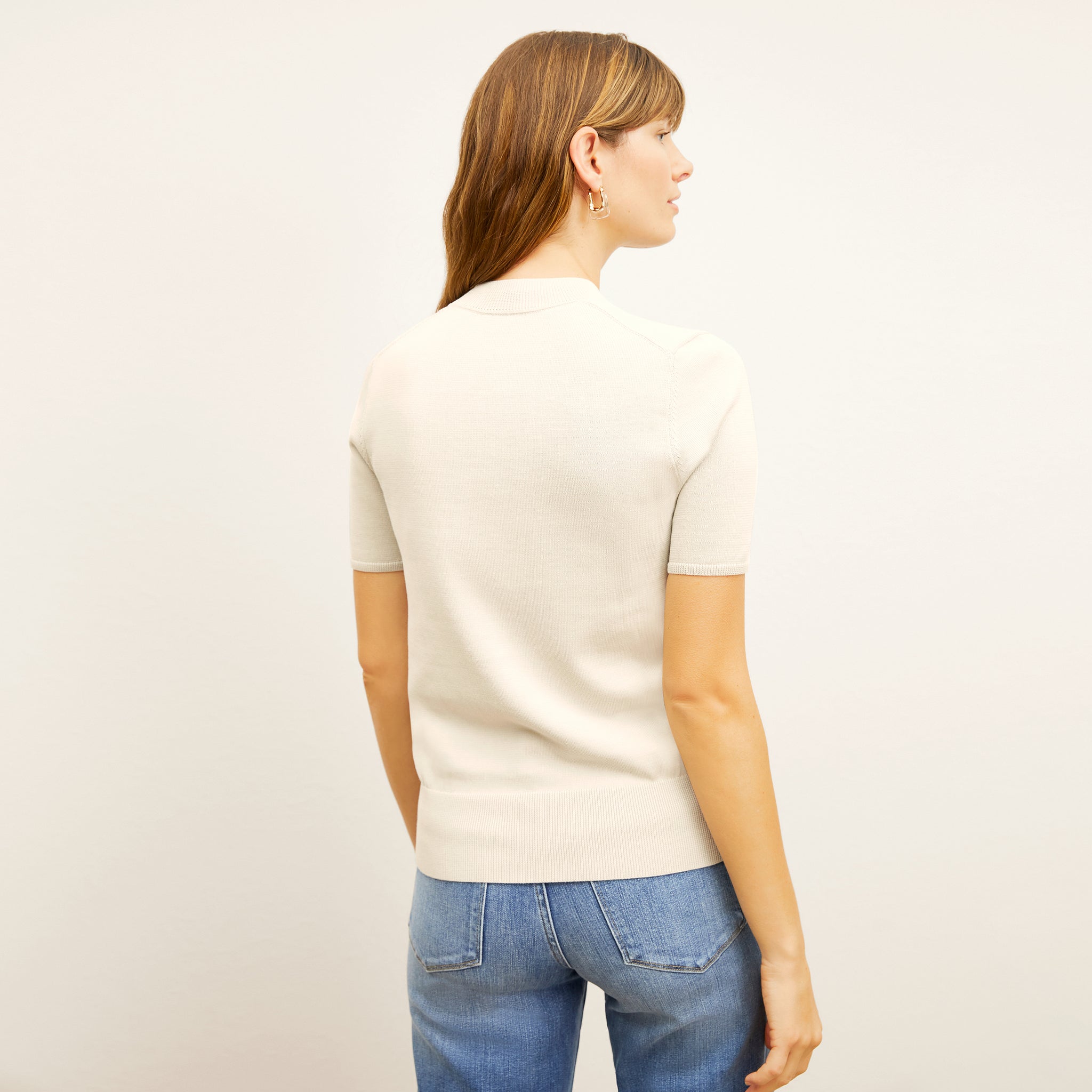back image of a woman wearing the shani top in ivory