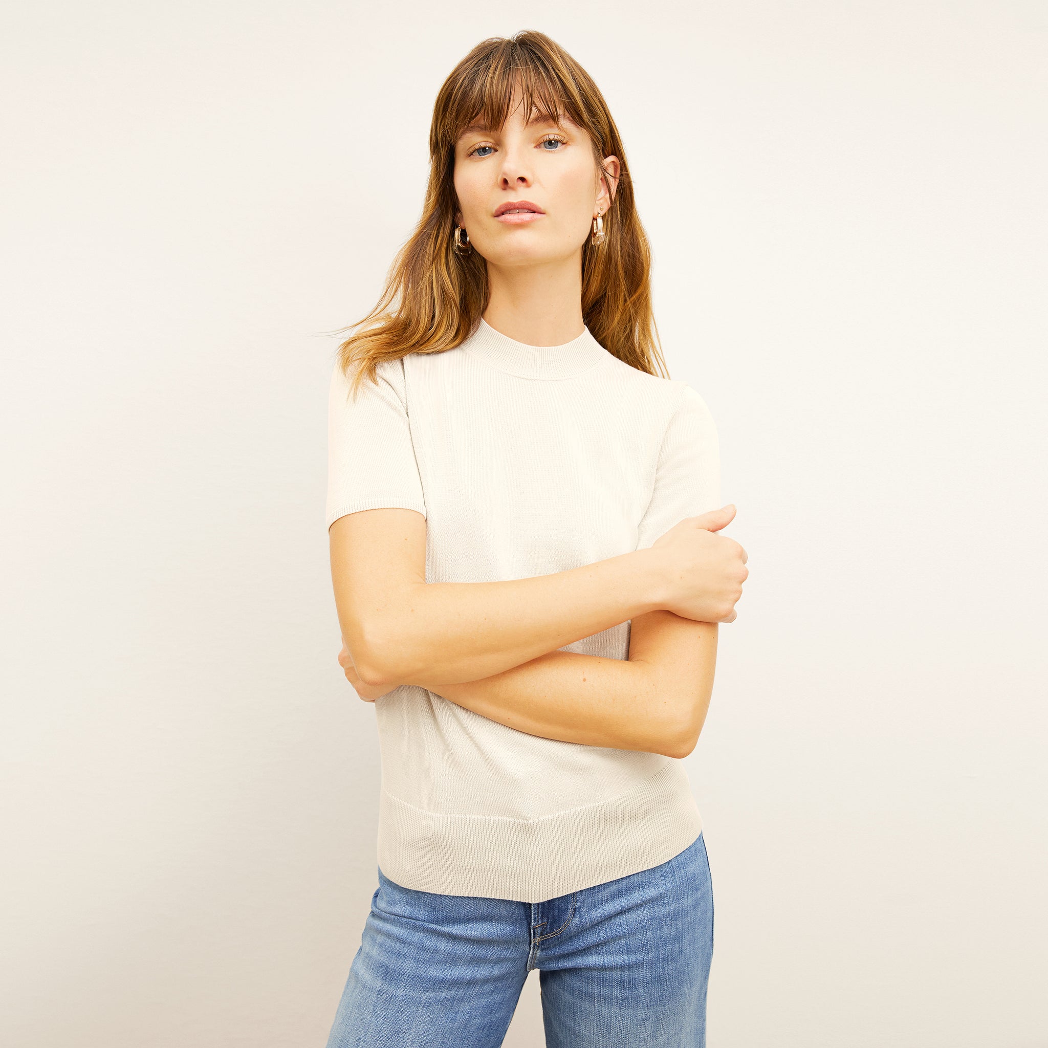 front image of a woman wearing the shani top in ivory 