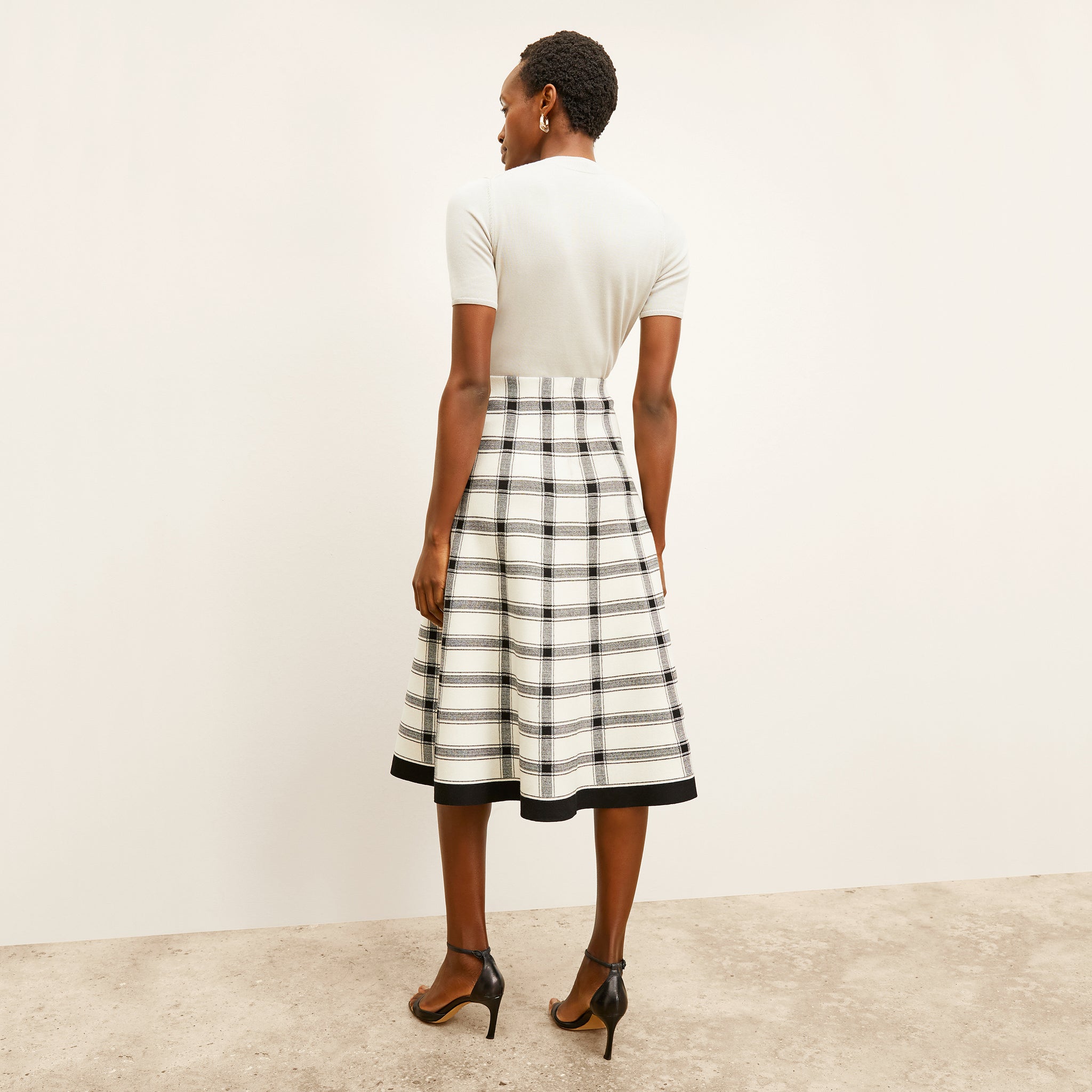 back image of a woman wearing the marlowe skirt in bold check