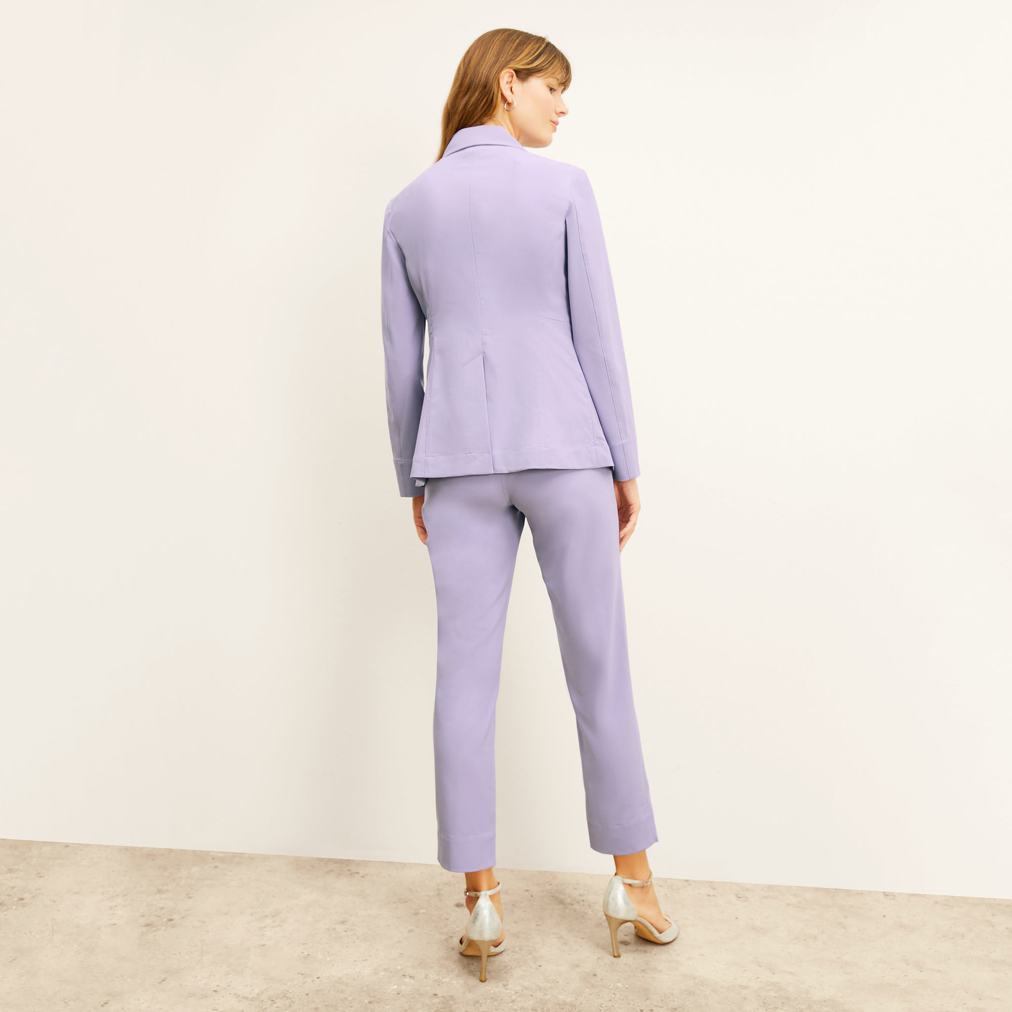 back image of a woman wearing the moreland jacket in light orchid 