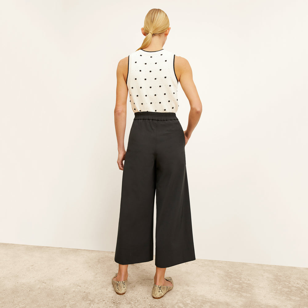 back image of a woman wearing the patty top in dot knit