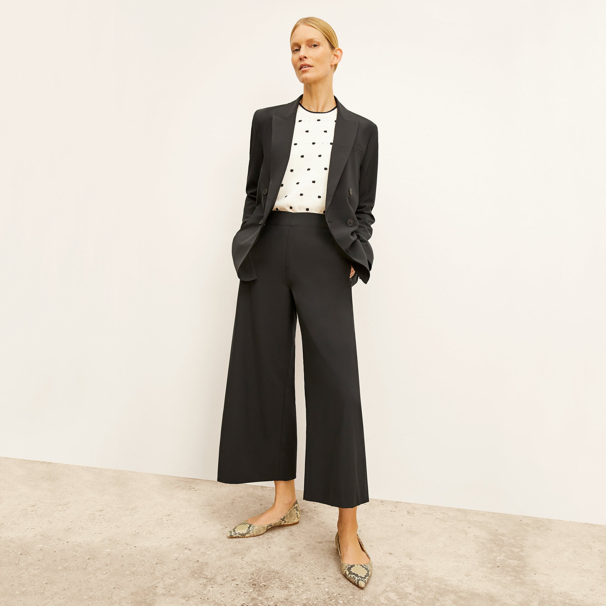 front image of a woman wearing the elena pants in black 