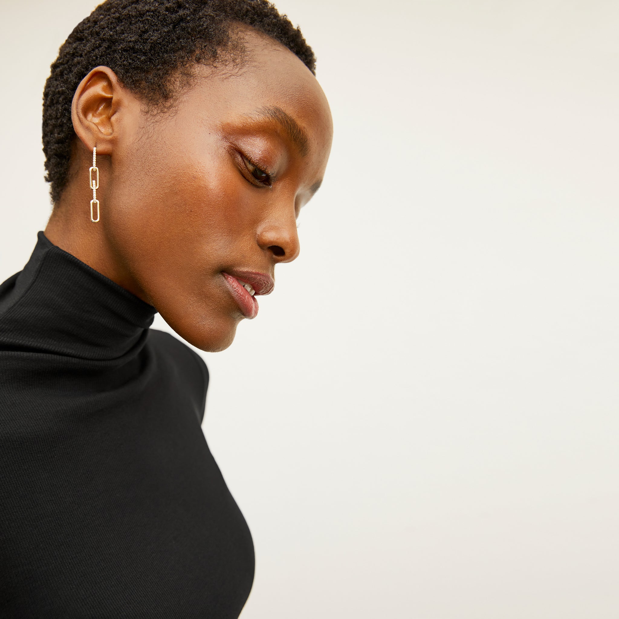 image of a woman wearing the martine earrings in gold