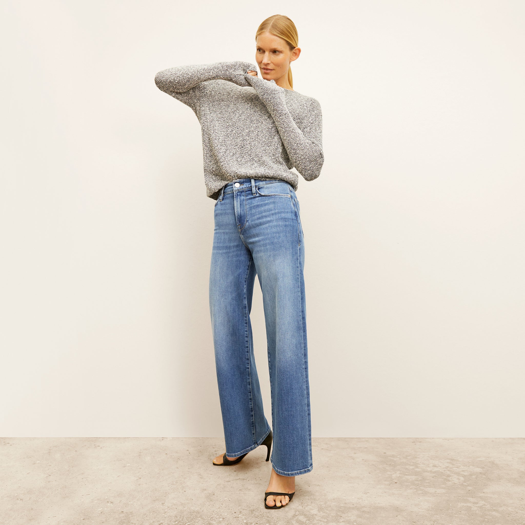 front image of a woman wearing the FRAME le slim palazzo jeans in drizzle