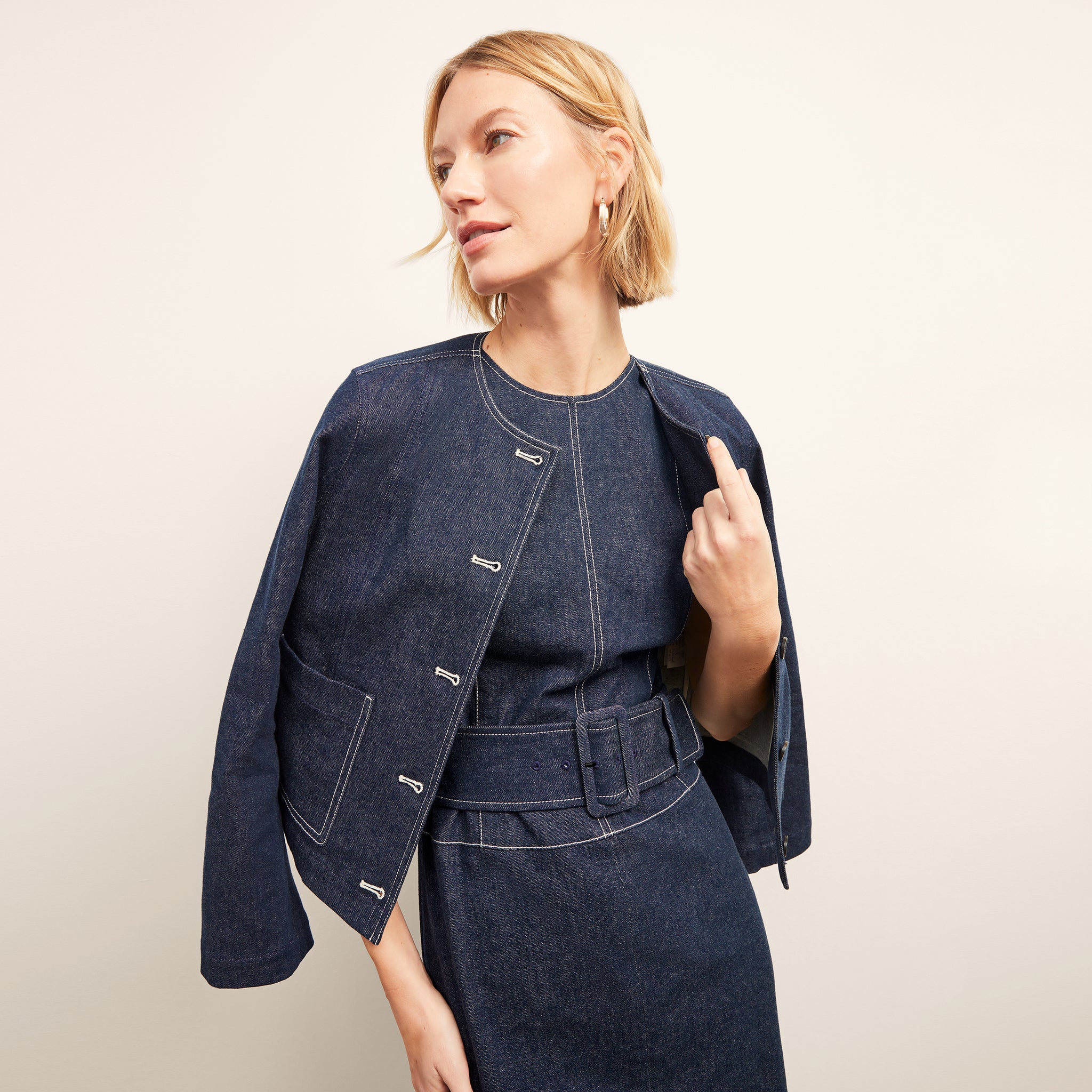 front image of a woman wearing the kane jacket in dark wash
