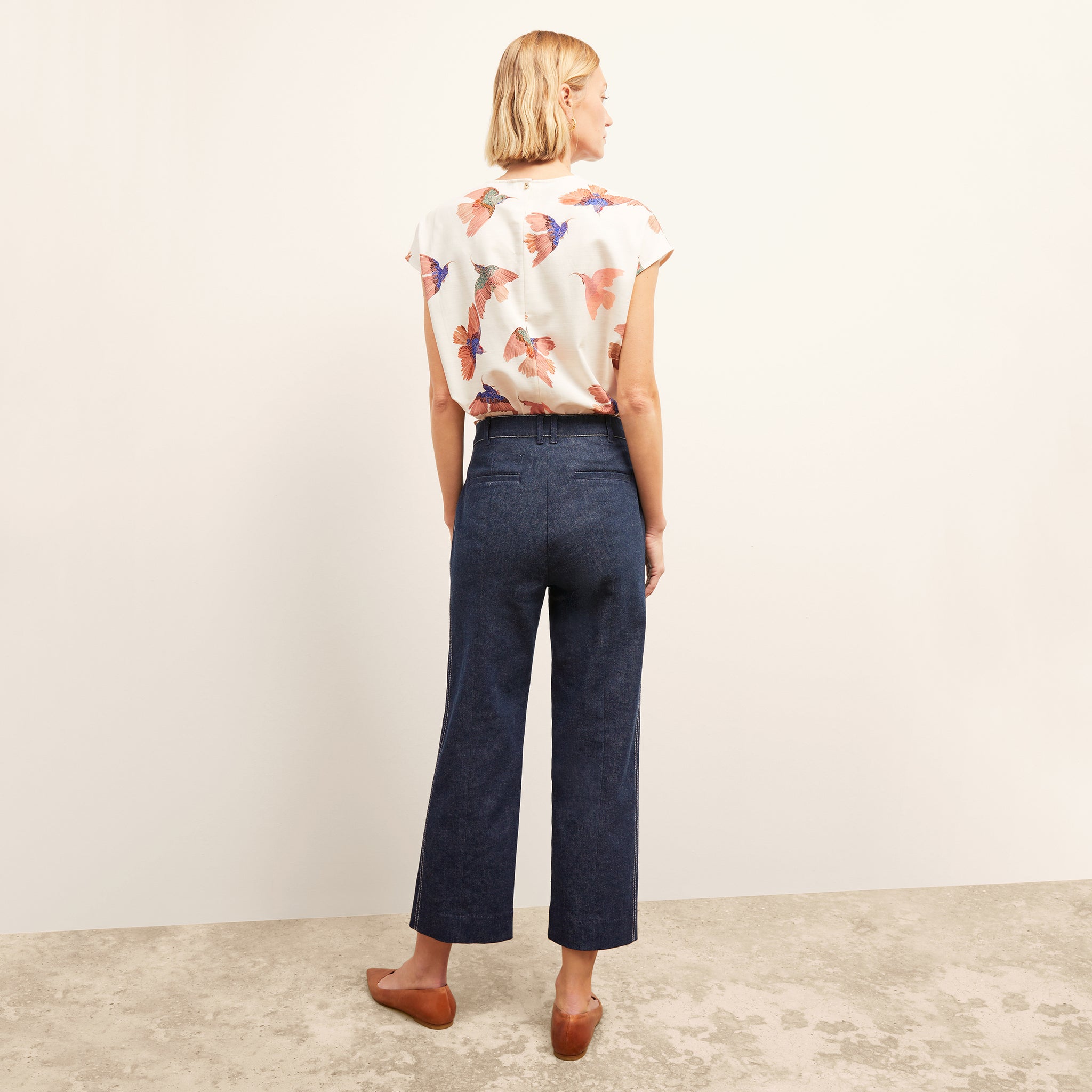 back image of a woman wearing the christy pant in dark wash